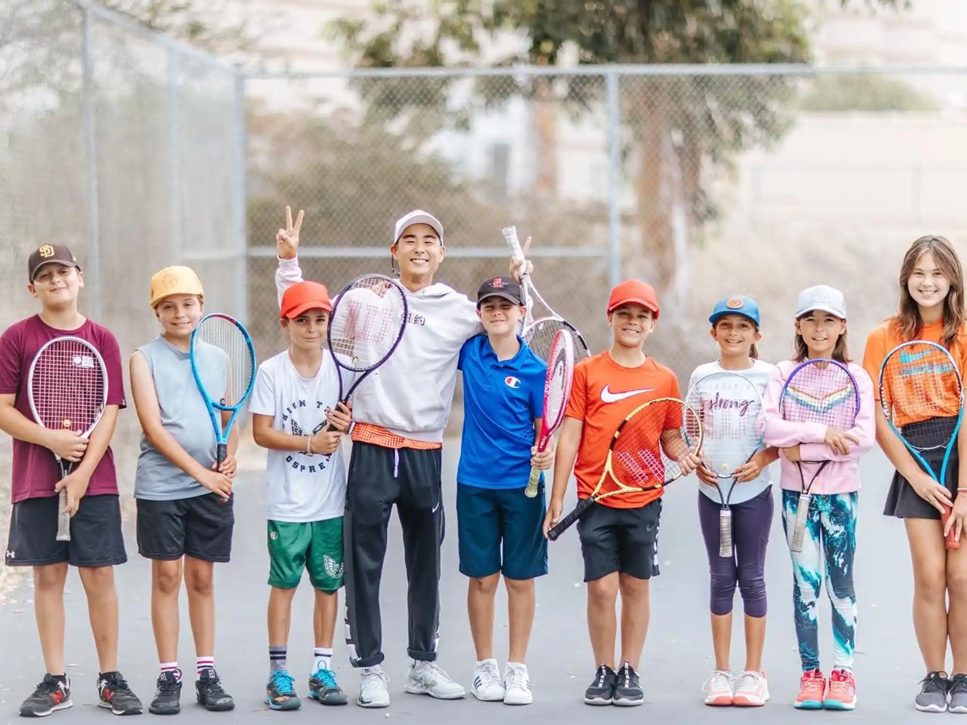 a group of people holding tennis rackets