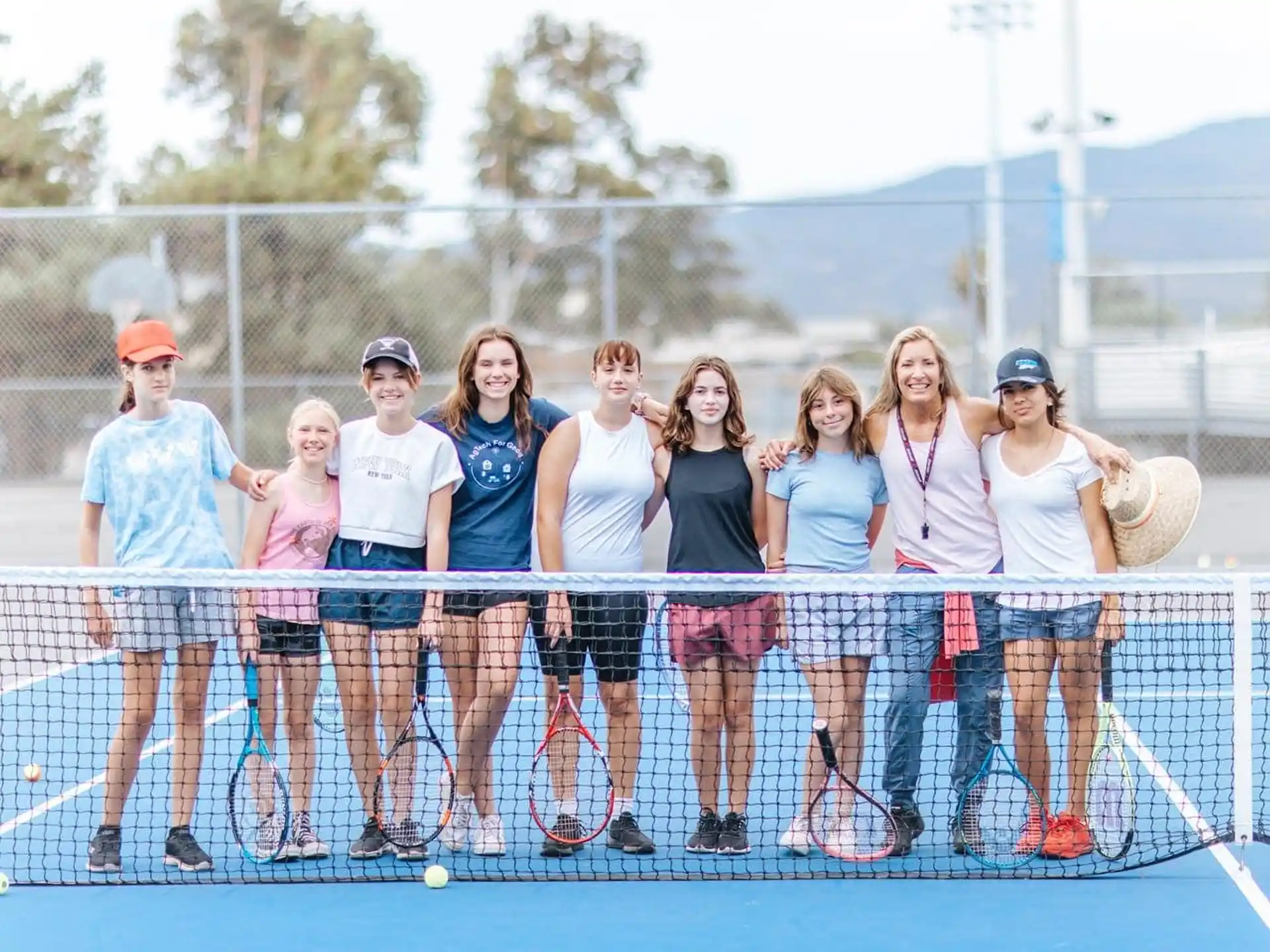 a group of women holding tennis rackets
