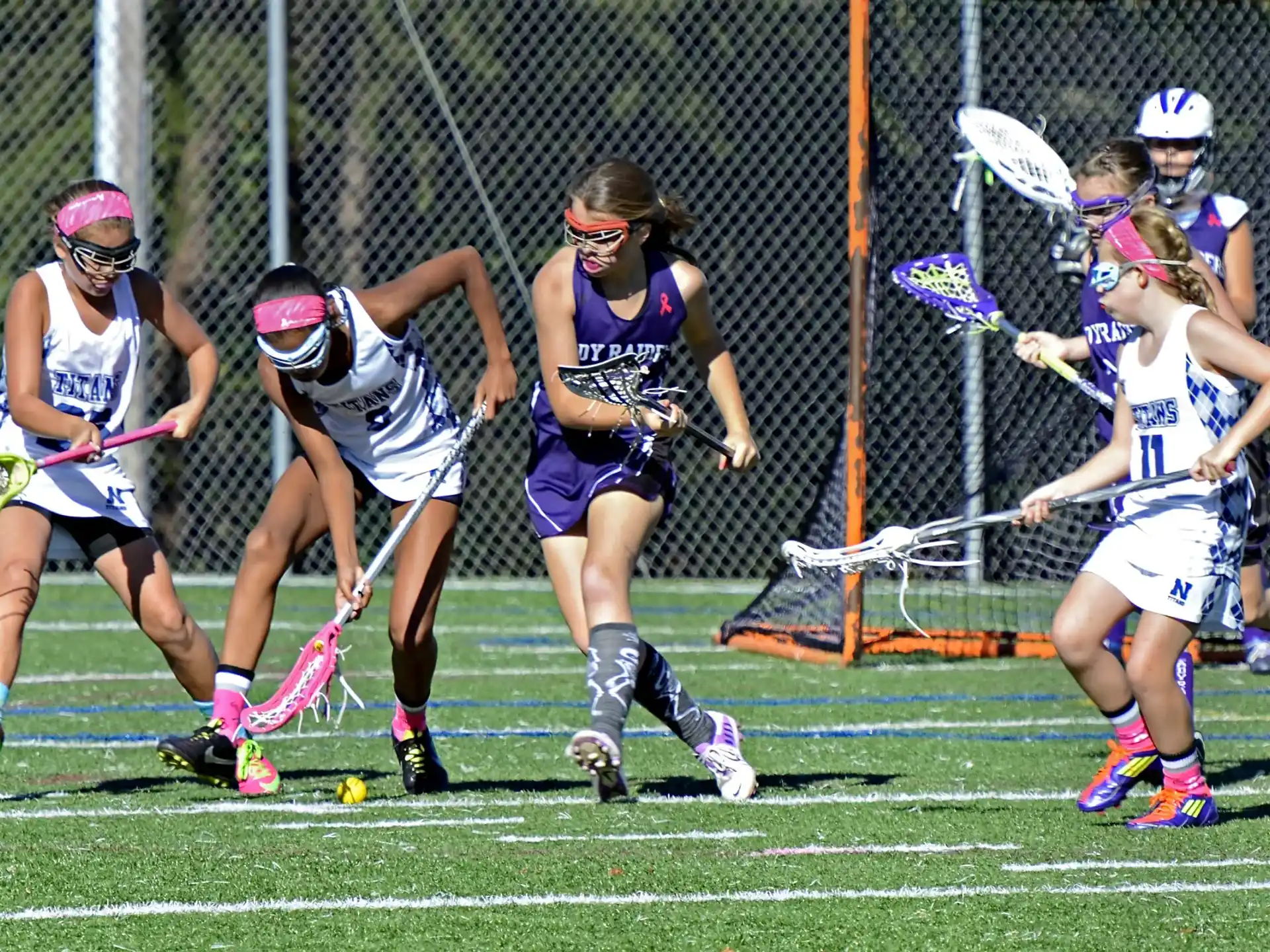 a group of women playing lacrosse