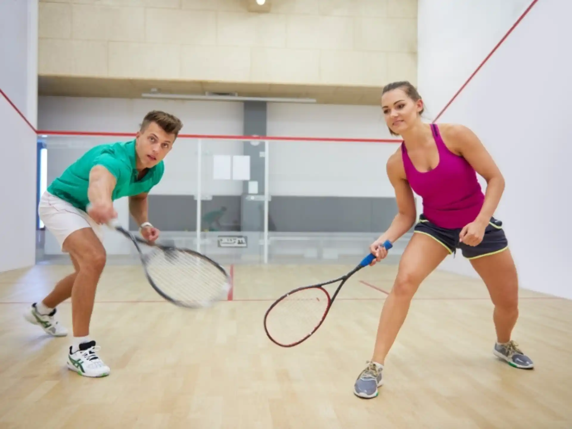 a couple of people playing tennis