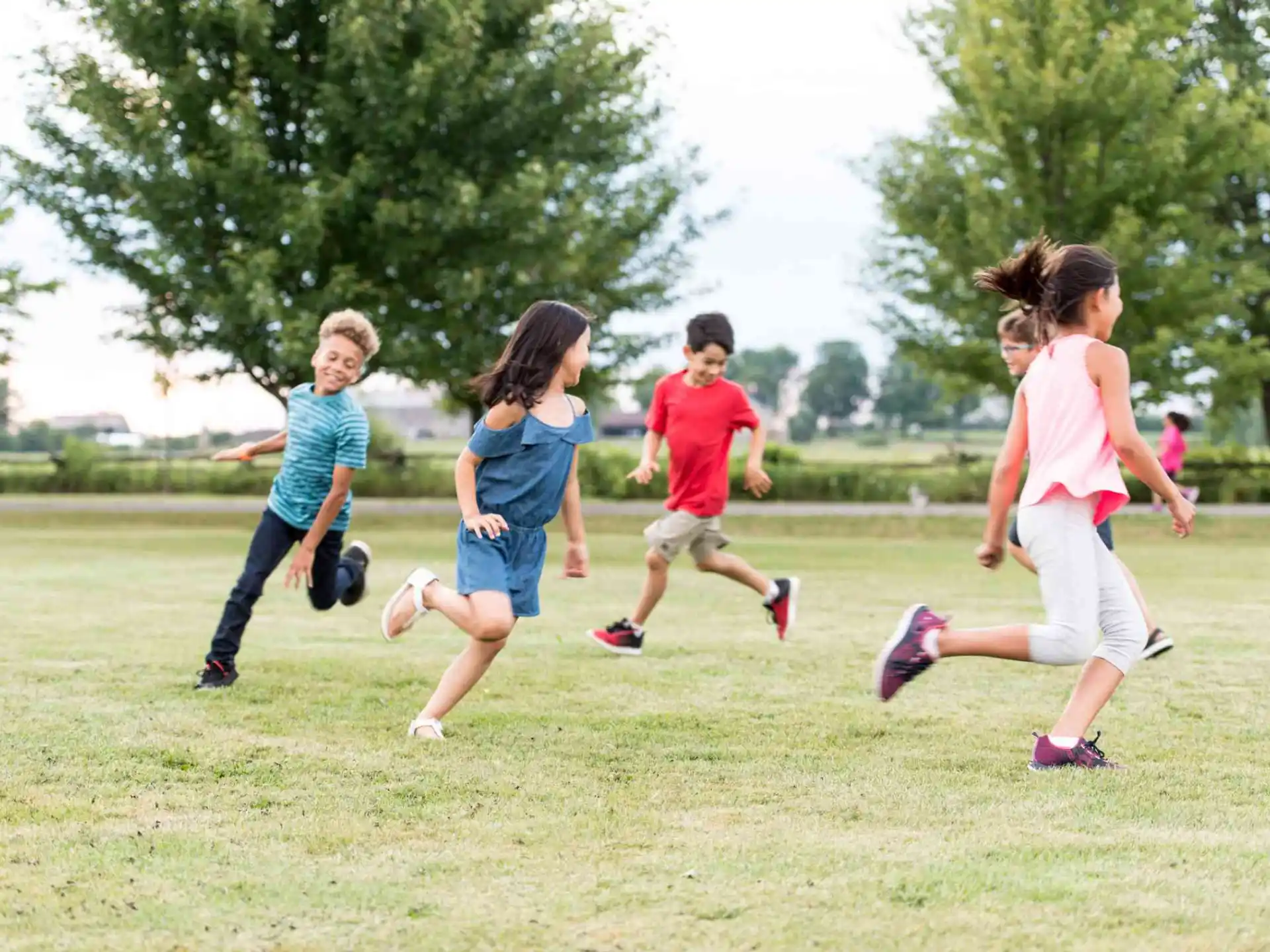 a group of children running on a field