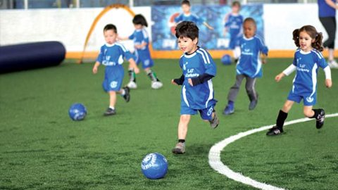kids playing football on a field