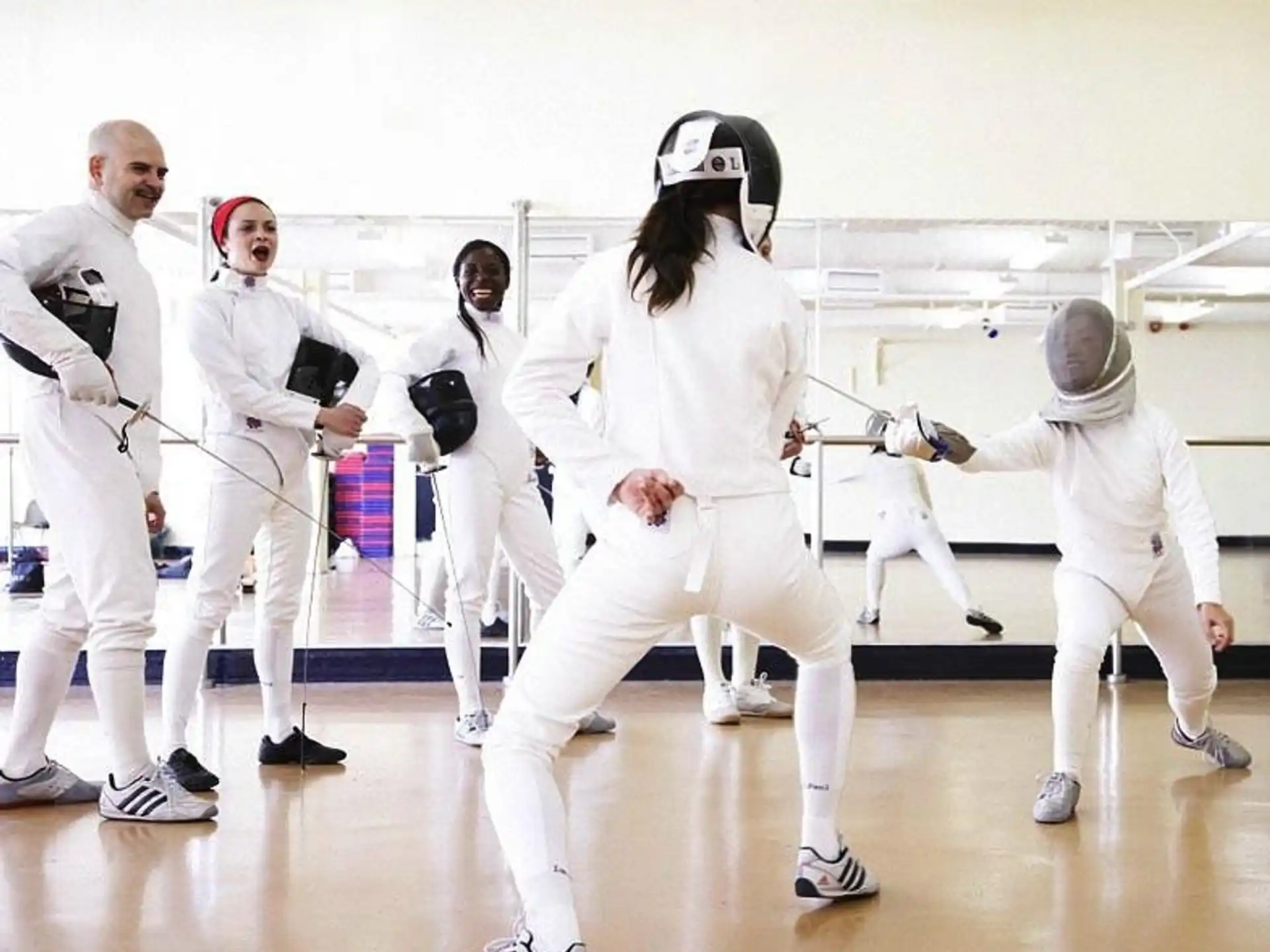 a group of people in white karate uniforms