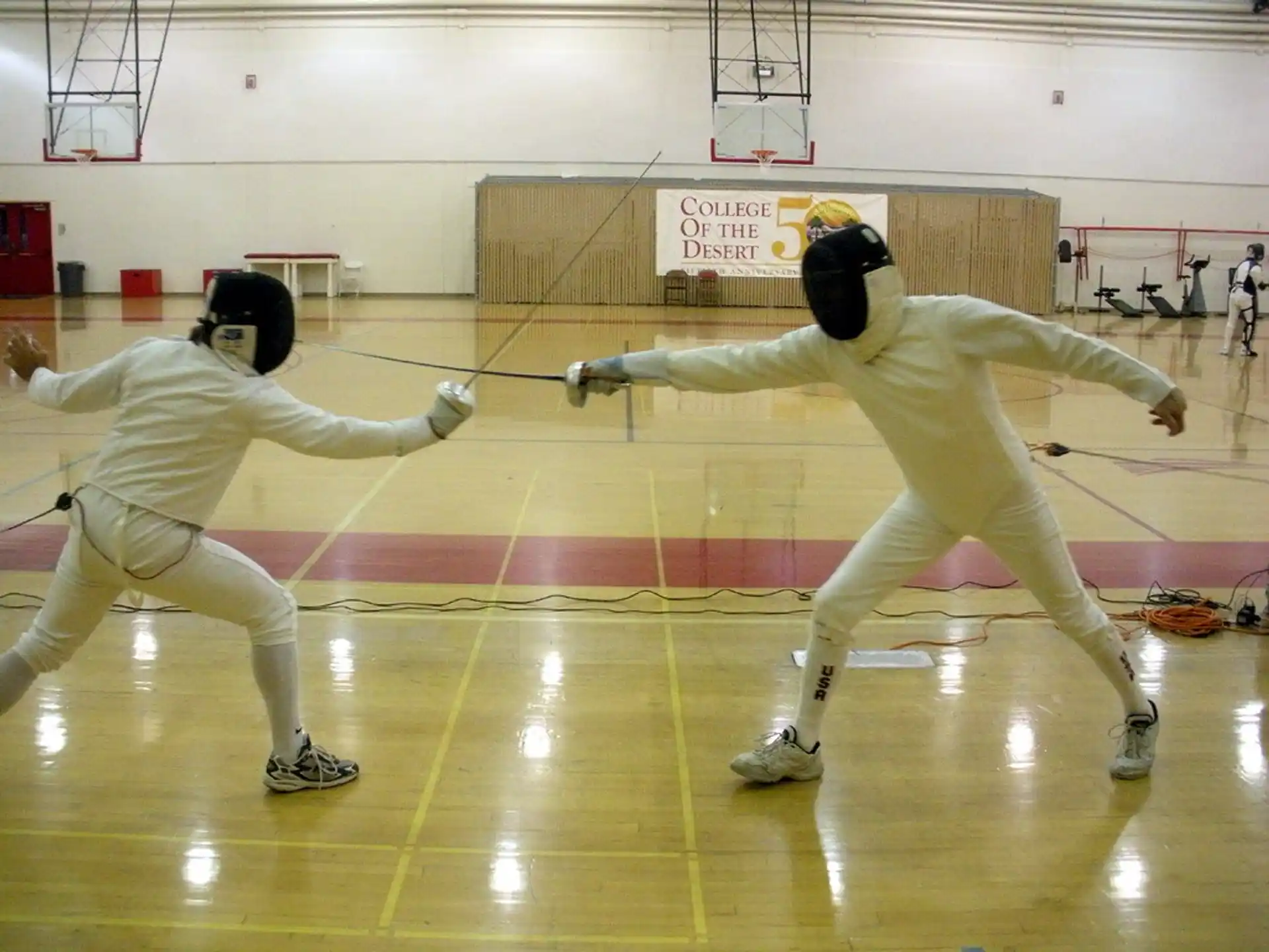 a group of people in white uniforms practicing martial arts