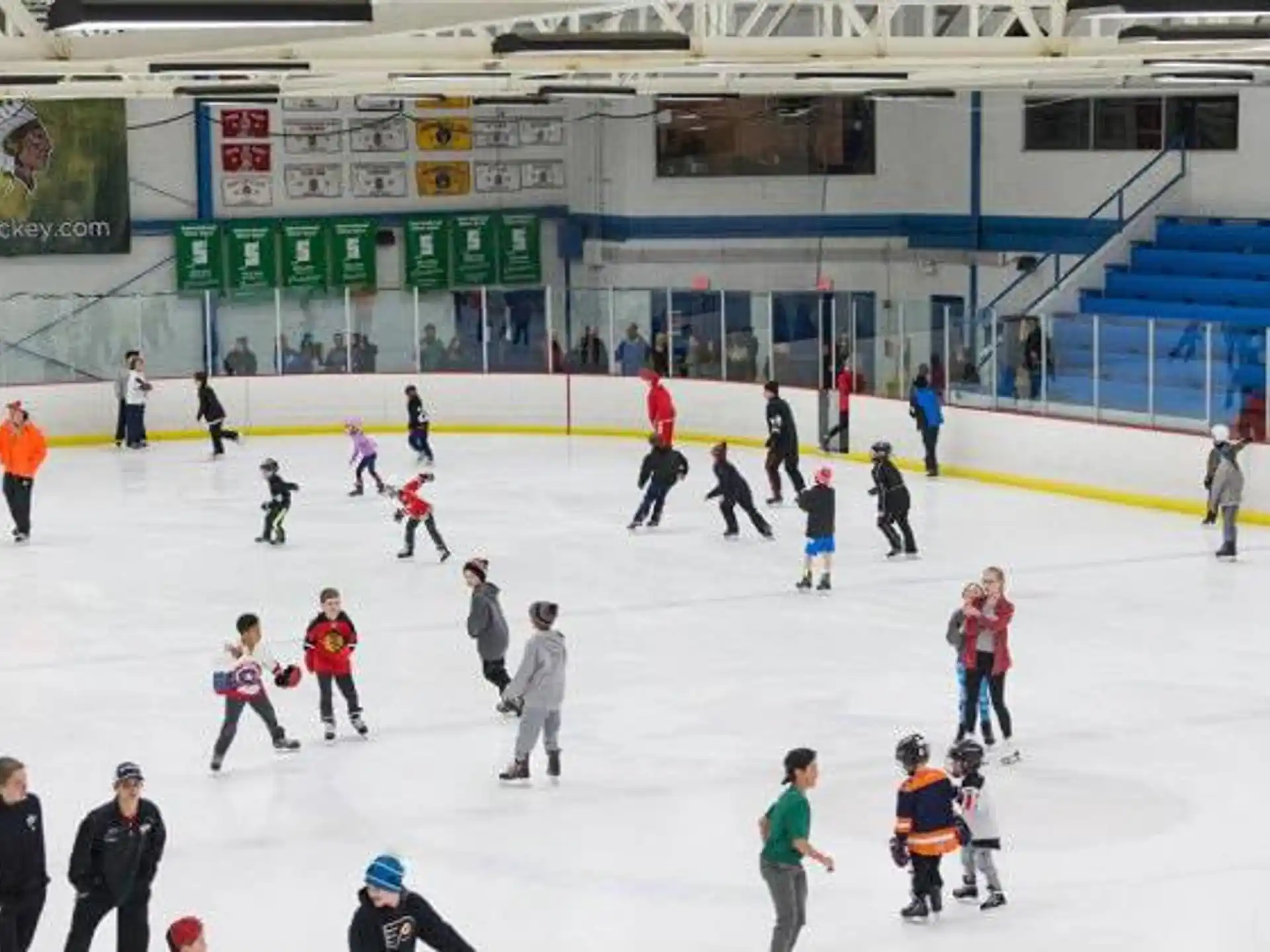 a group of people on an ice rink with ice and snow