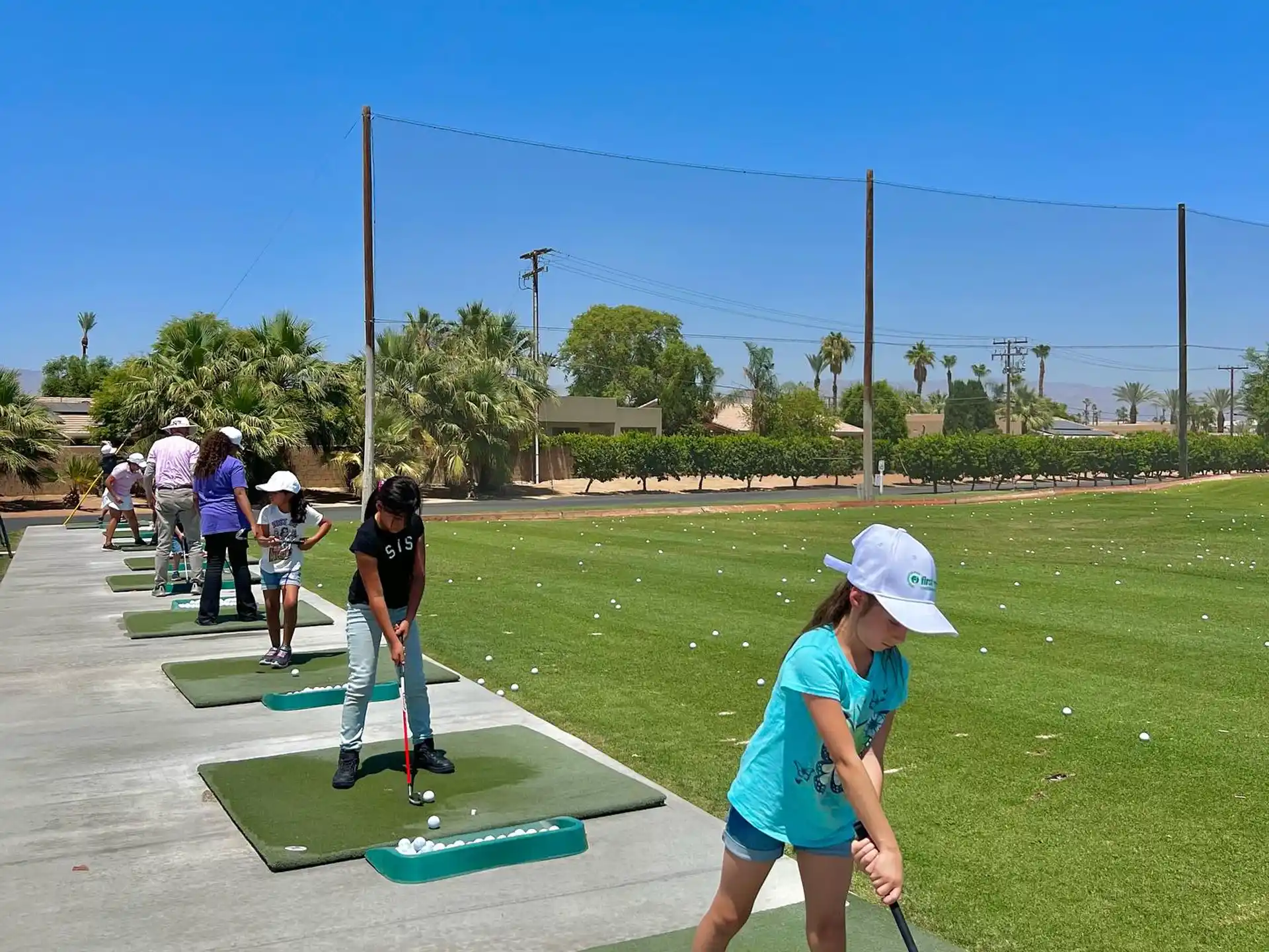 a girl playing miniature golf