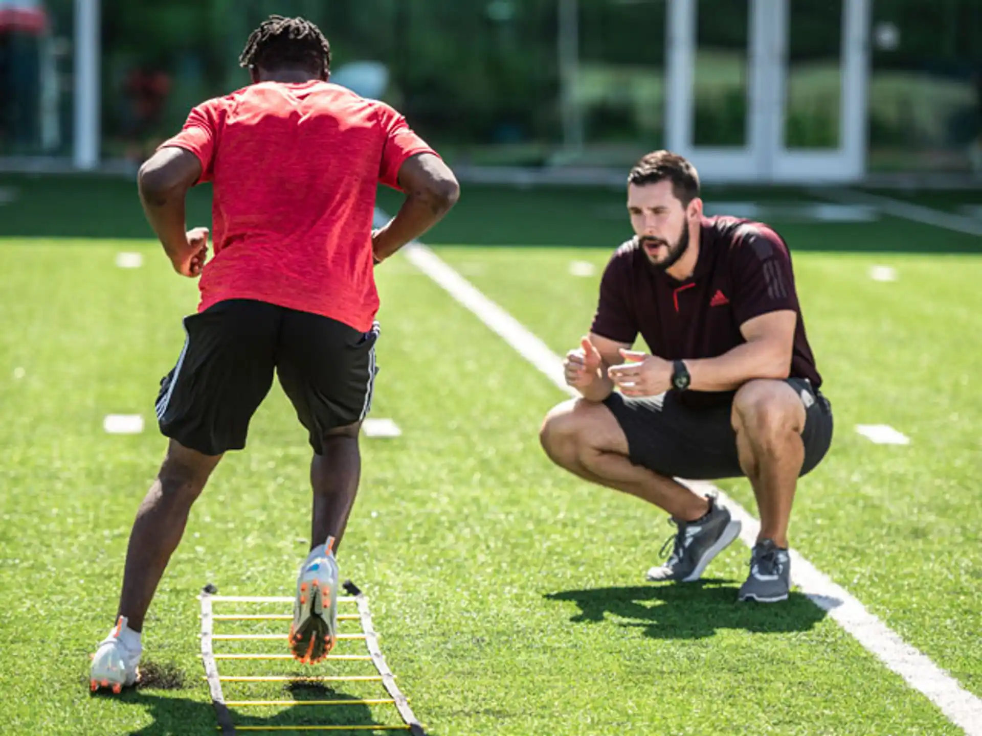 two men running on a grass field
