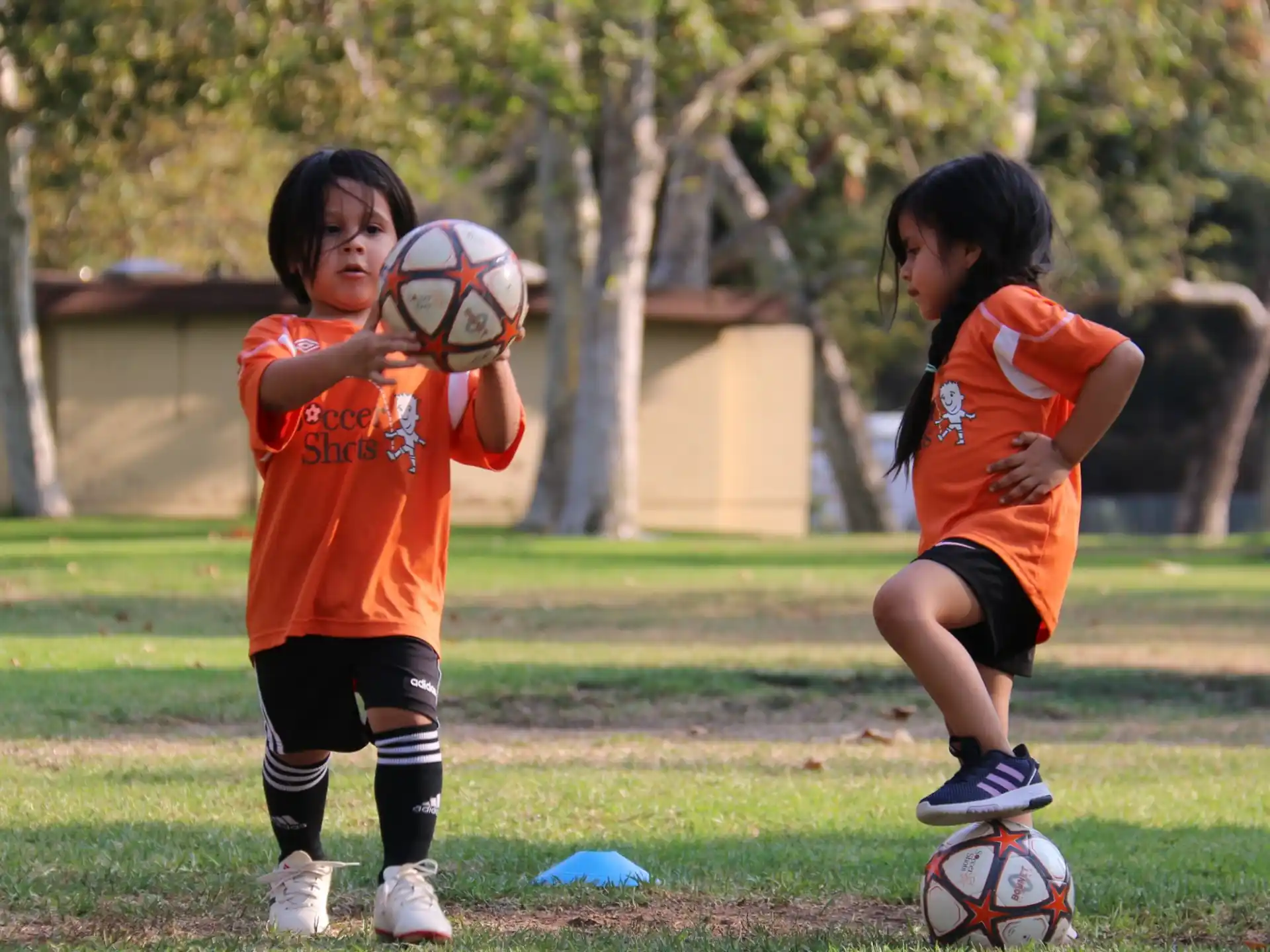 kids playing with football balls