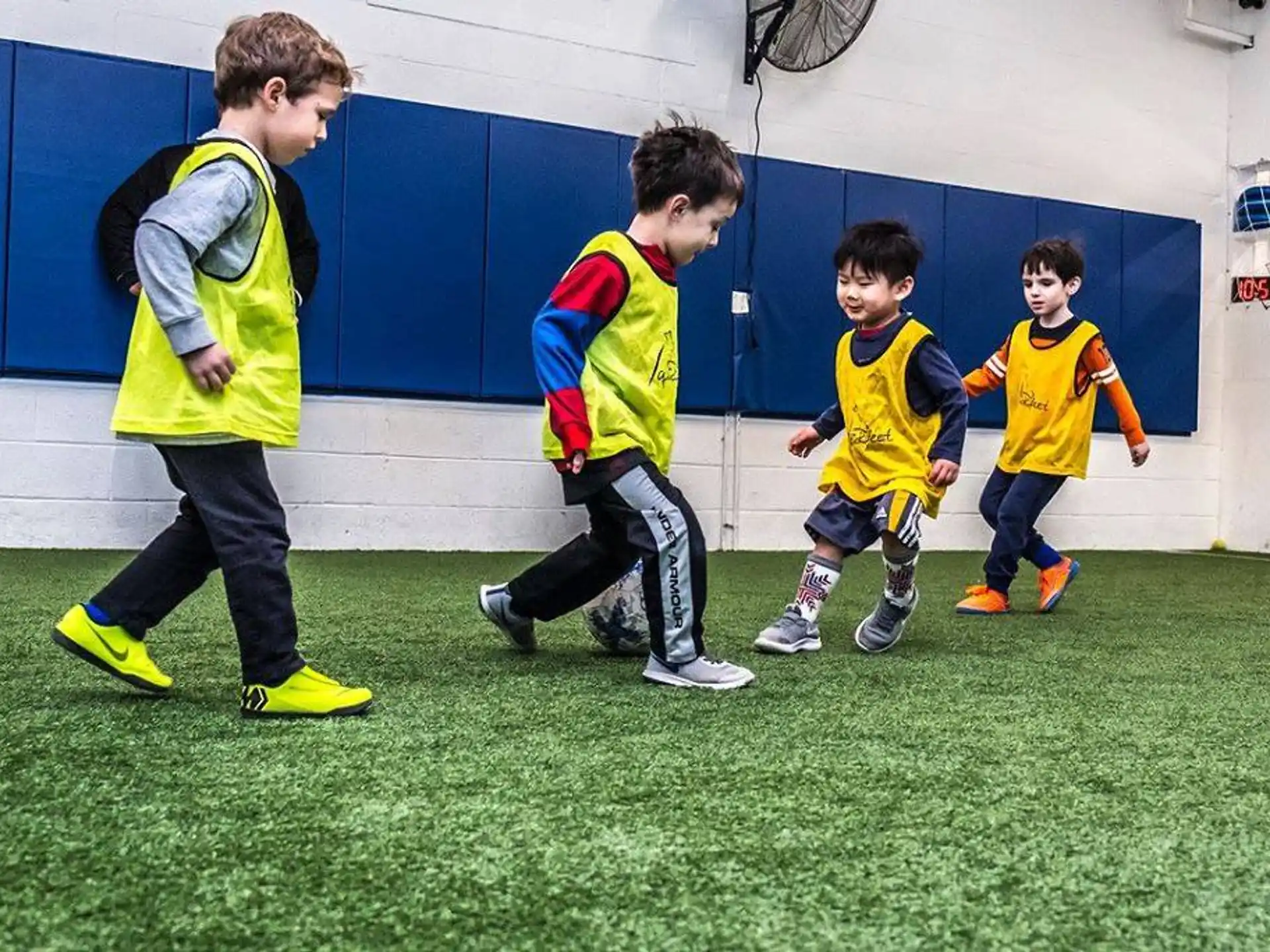a group of boys in yellow uniforms running on a field