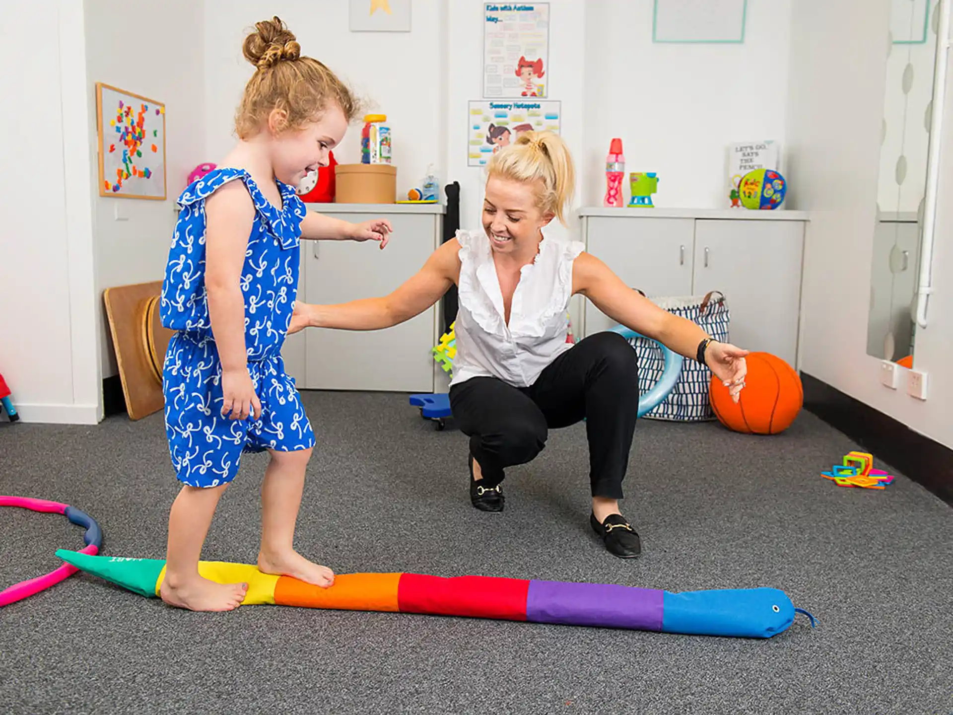 a couple of girls playing with a toy