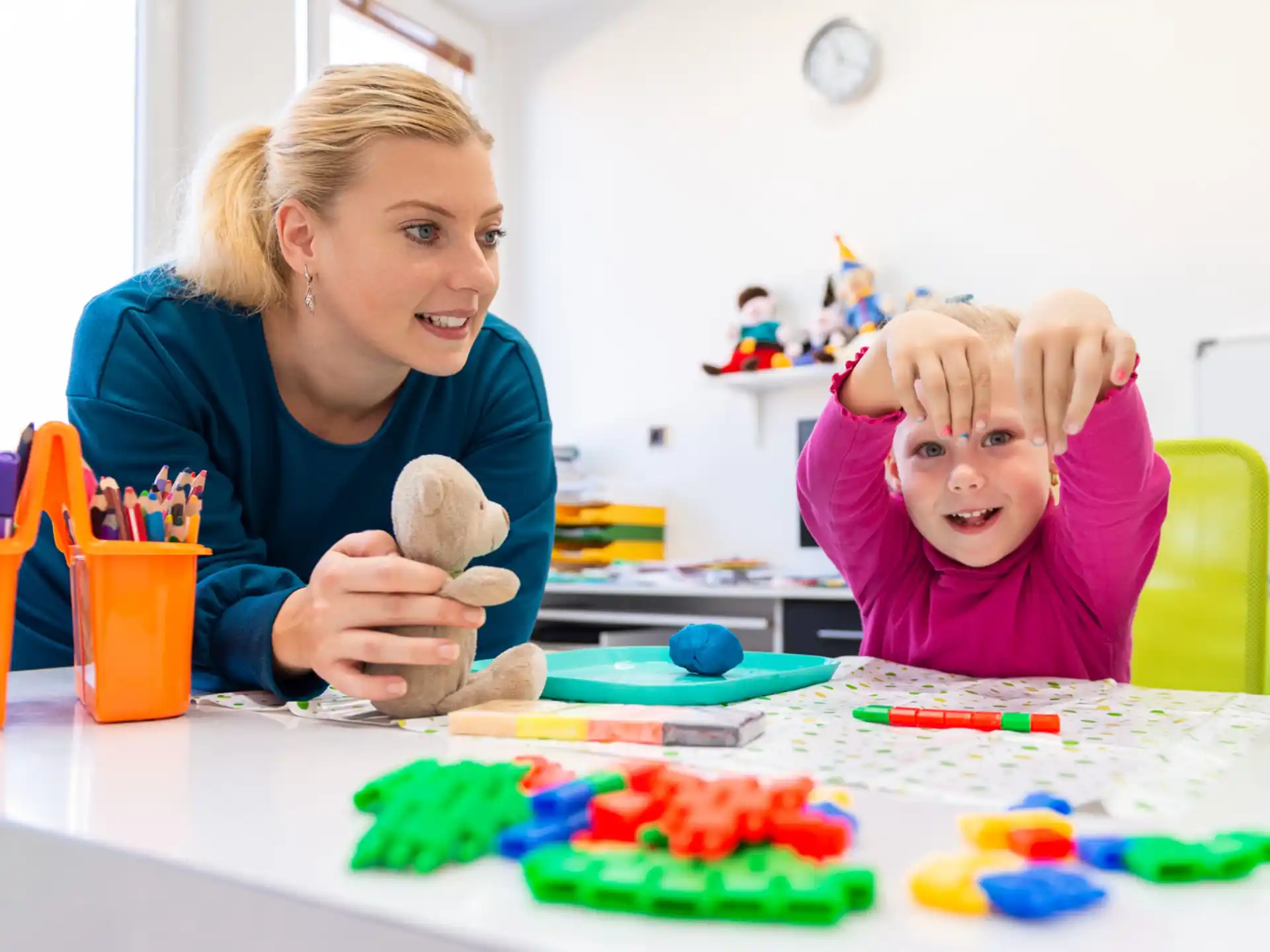 a person and a child playing with toys