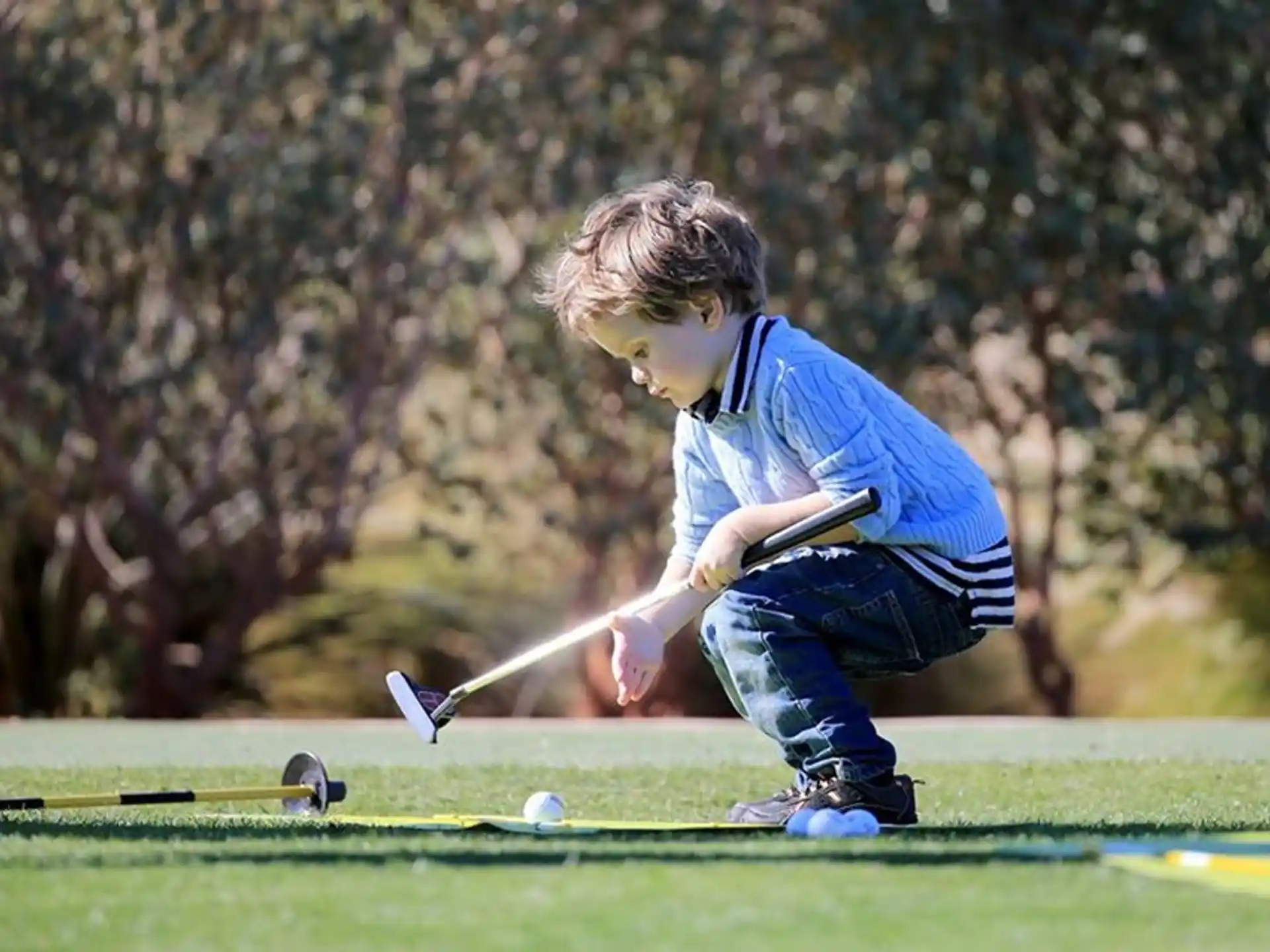 a boy playing golf
