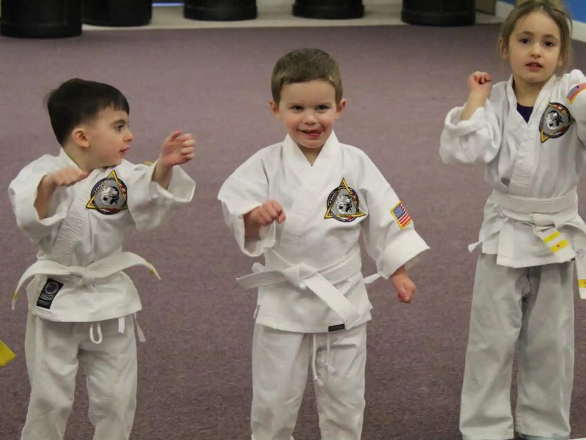 a group of children in white karate uniforms