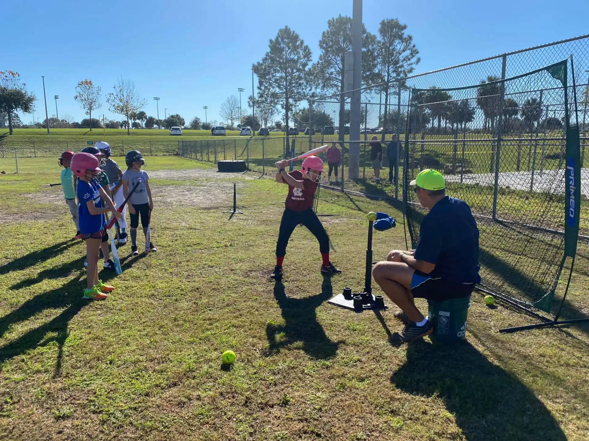 a group of kids playing tee ball