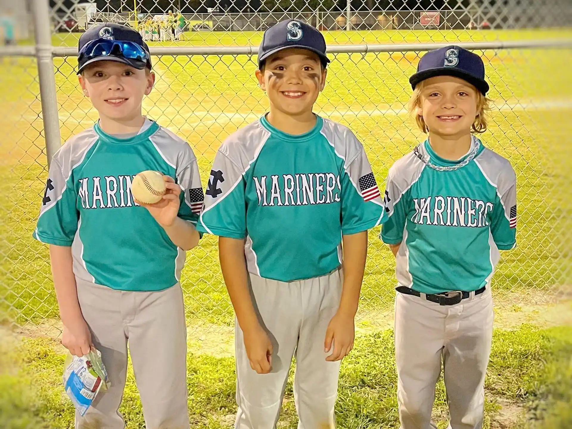 a group of kids wearing baseball uniforms