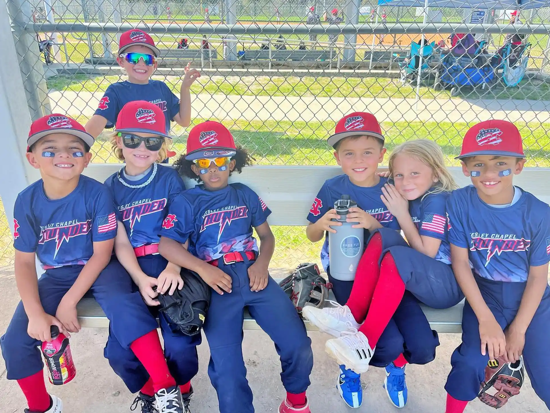 a group of kids wearing baseball uniforms
