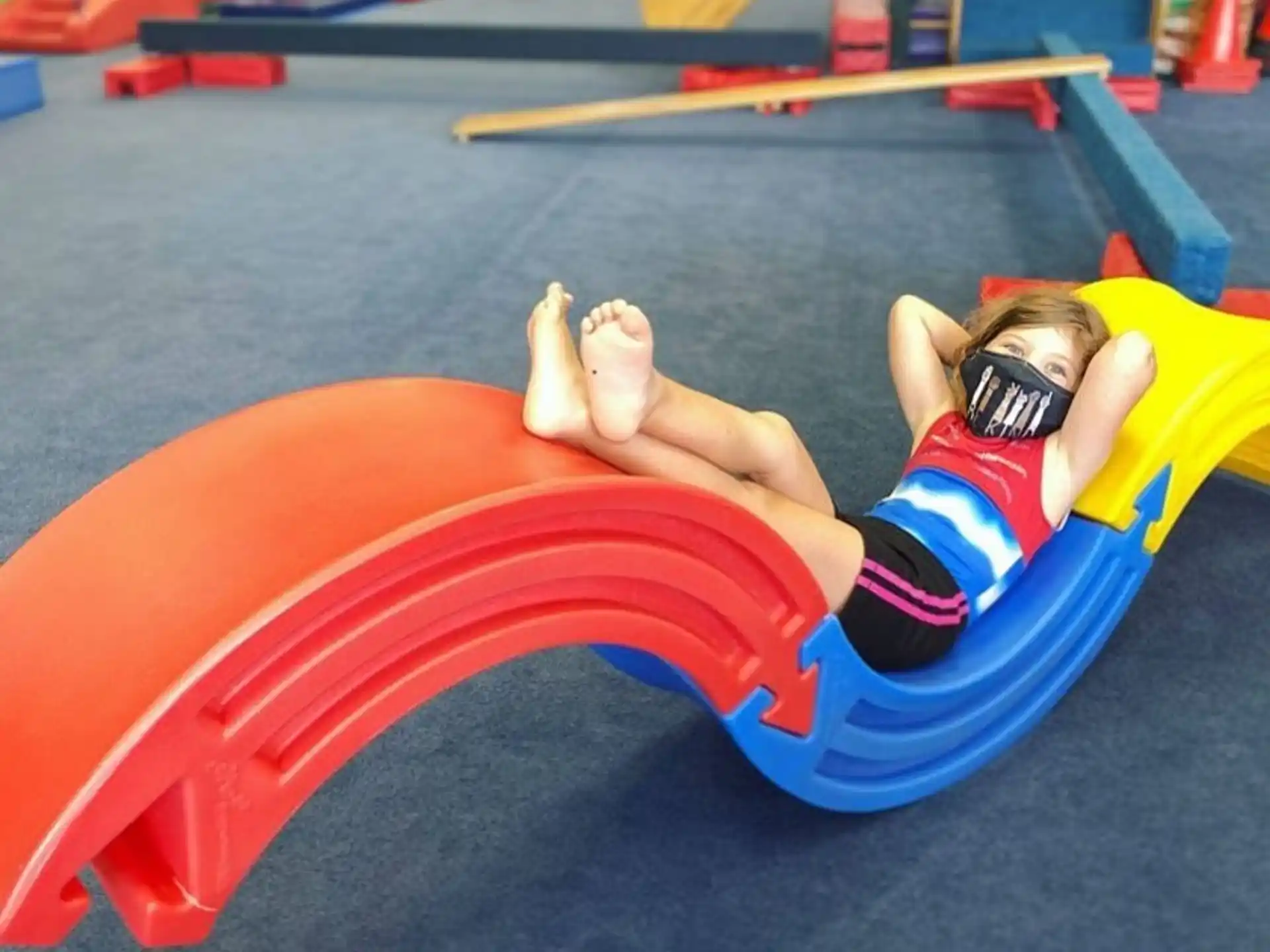 a person lying on a red and yellow tube