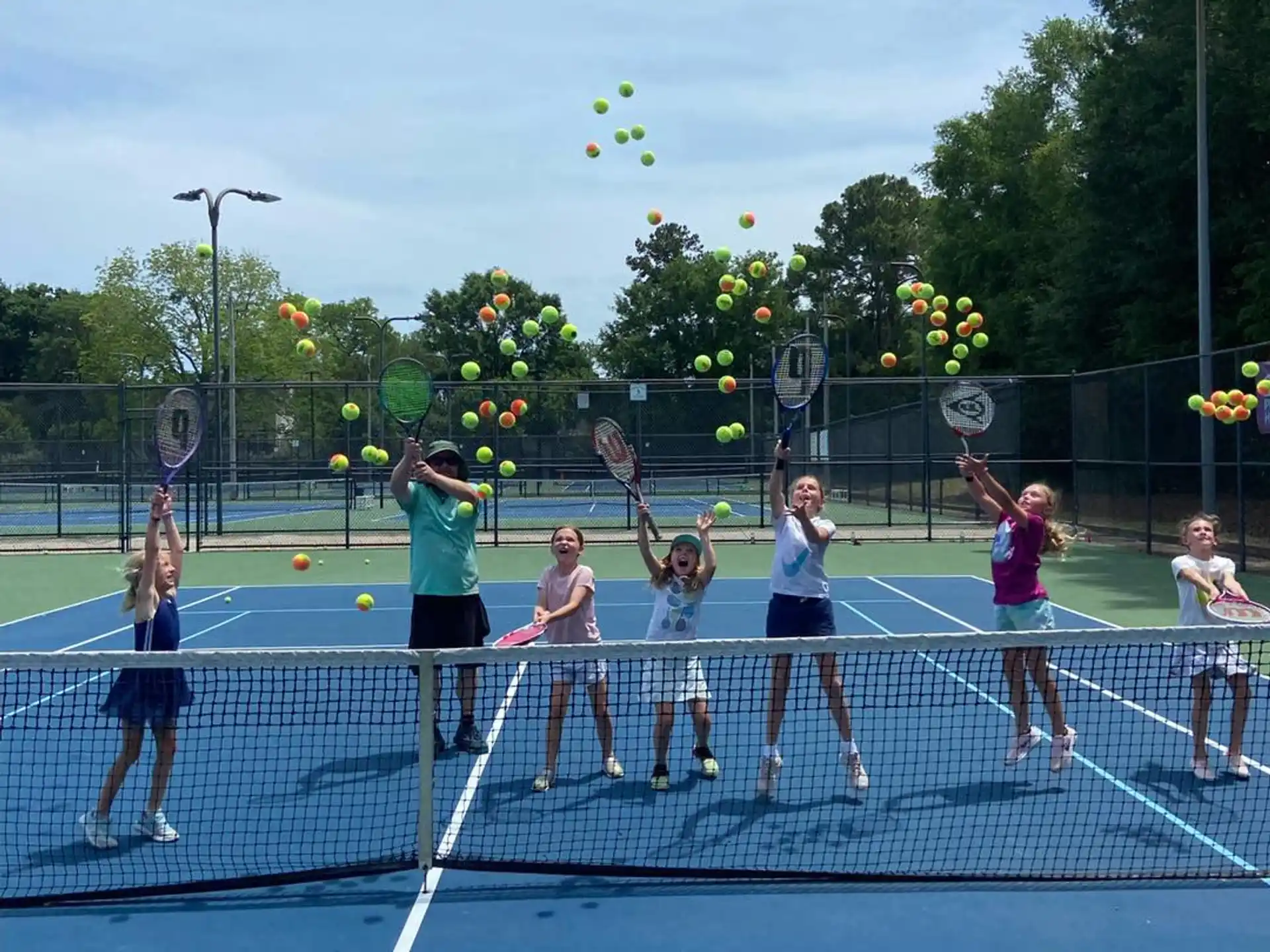 a group of girls playing tennis