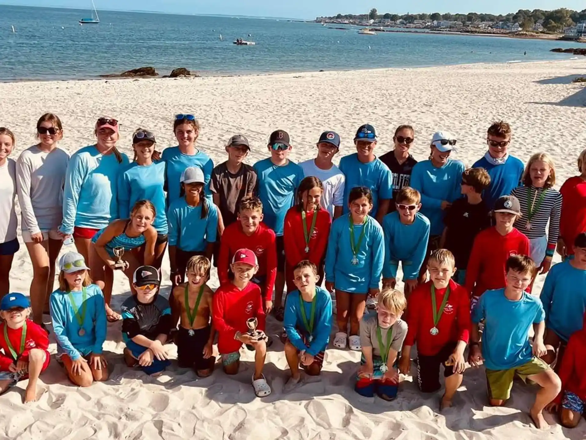 a group of people posing for a photo on a beach