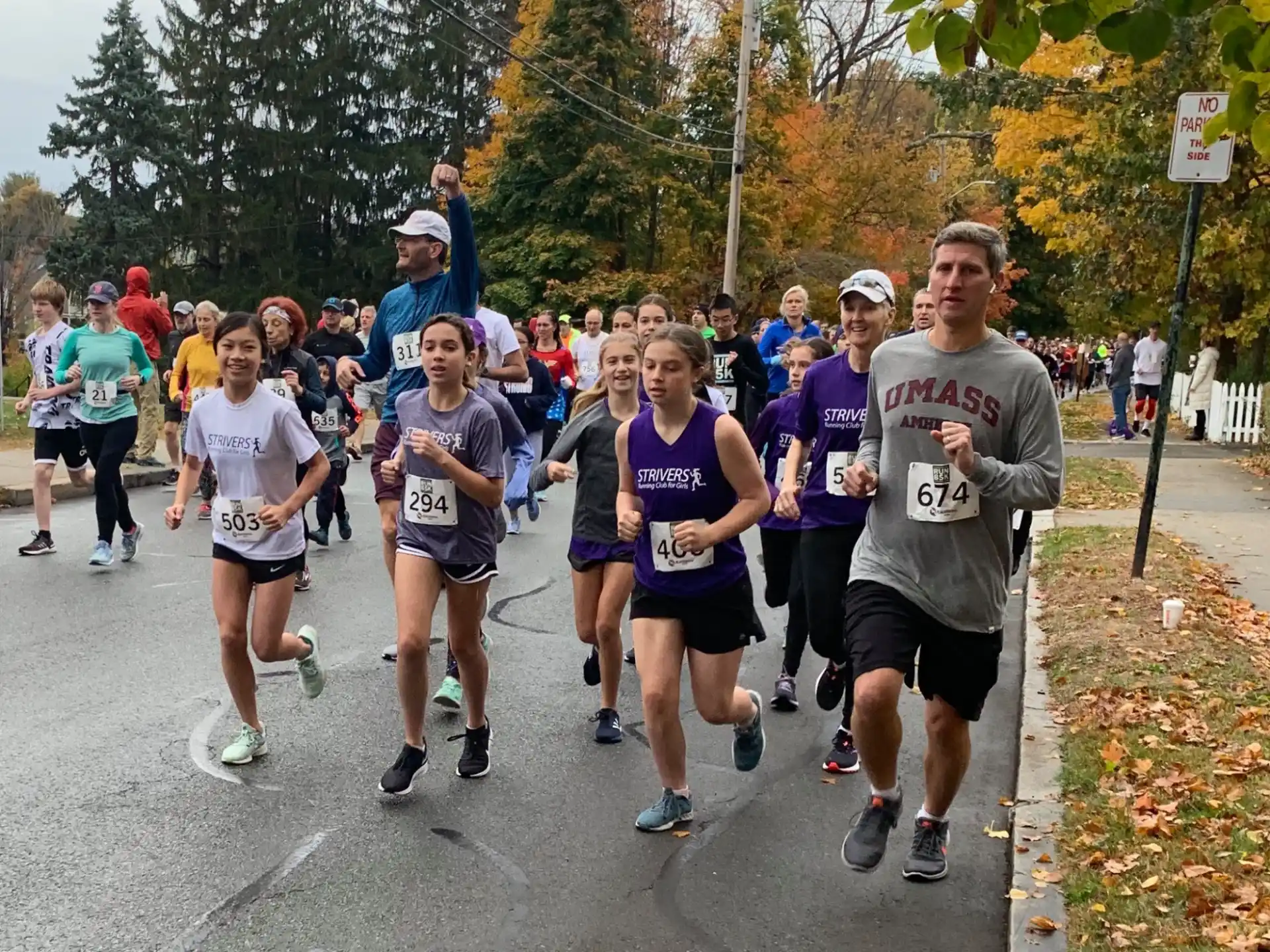 a group of people running on a road