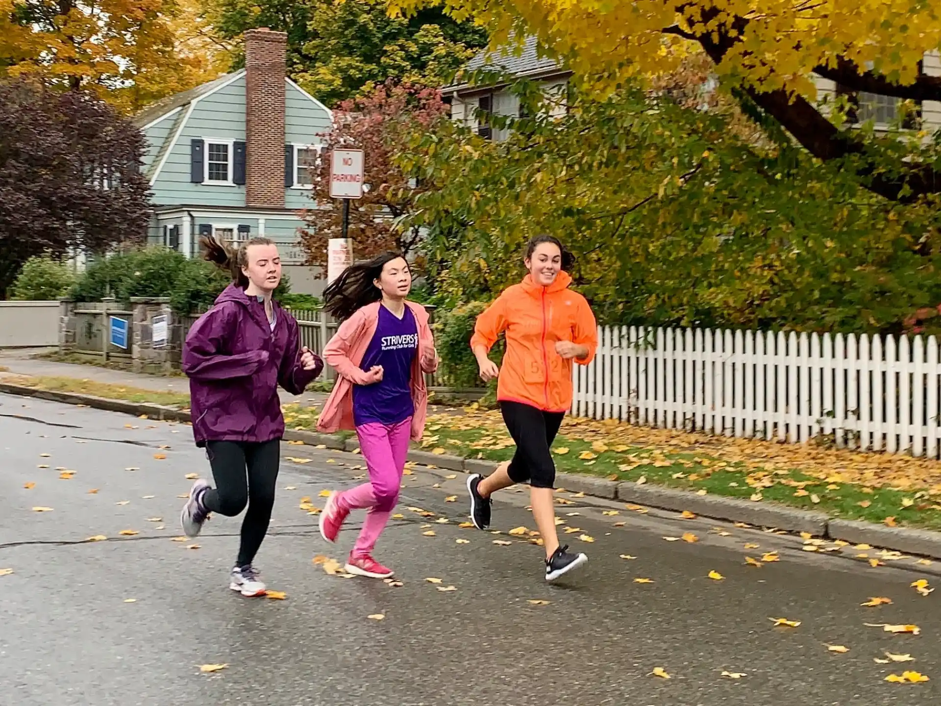 a group of people running on a street