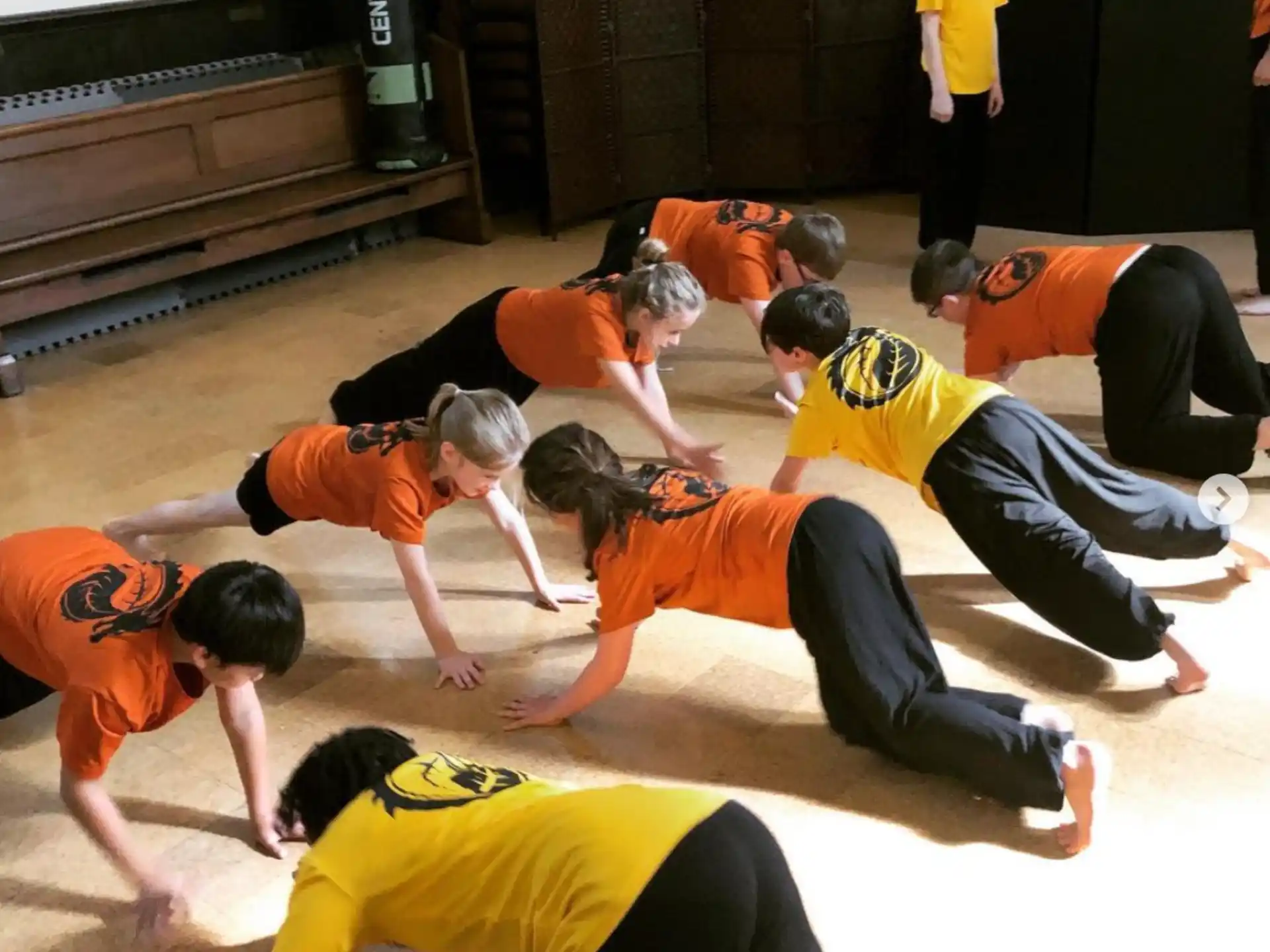 a group of people in orange shirts