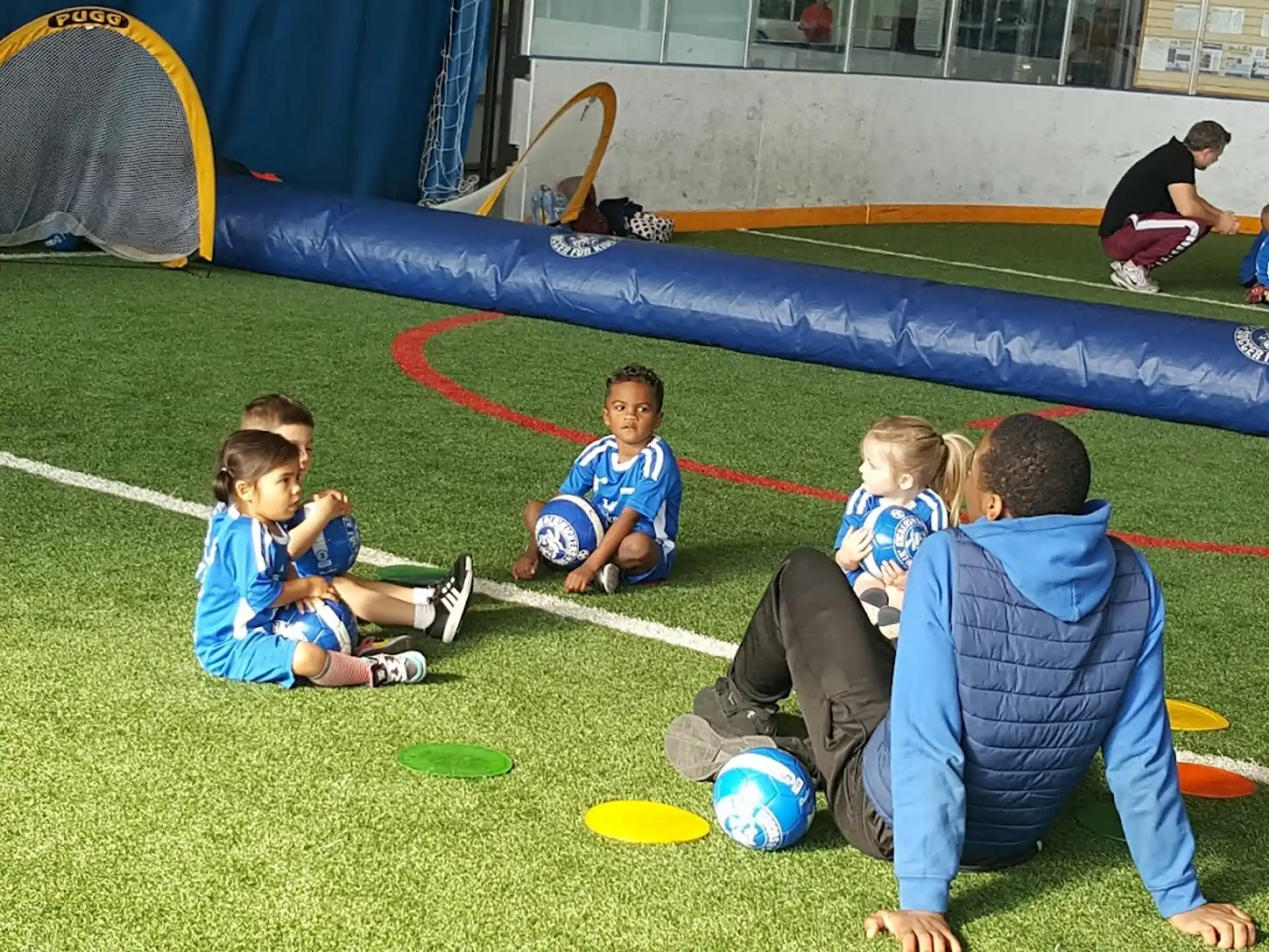 a group of kids sitting on the grass