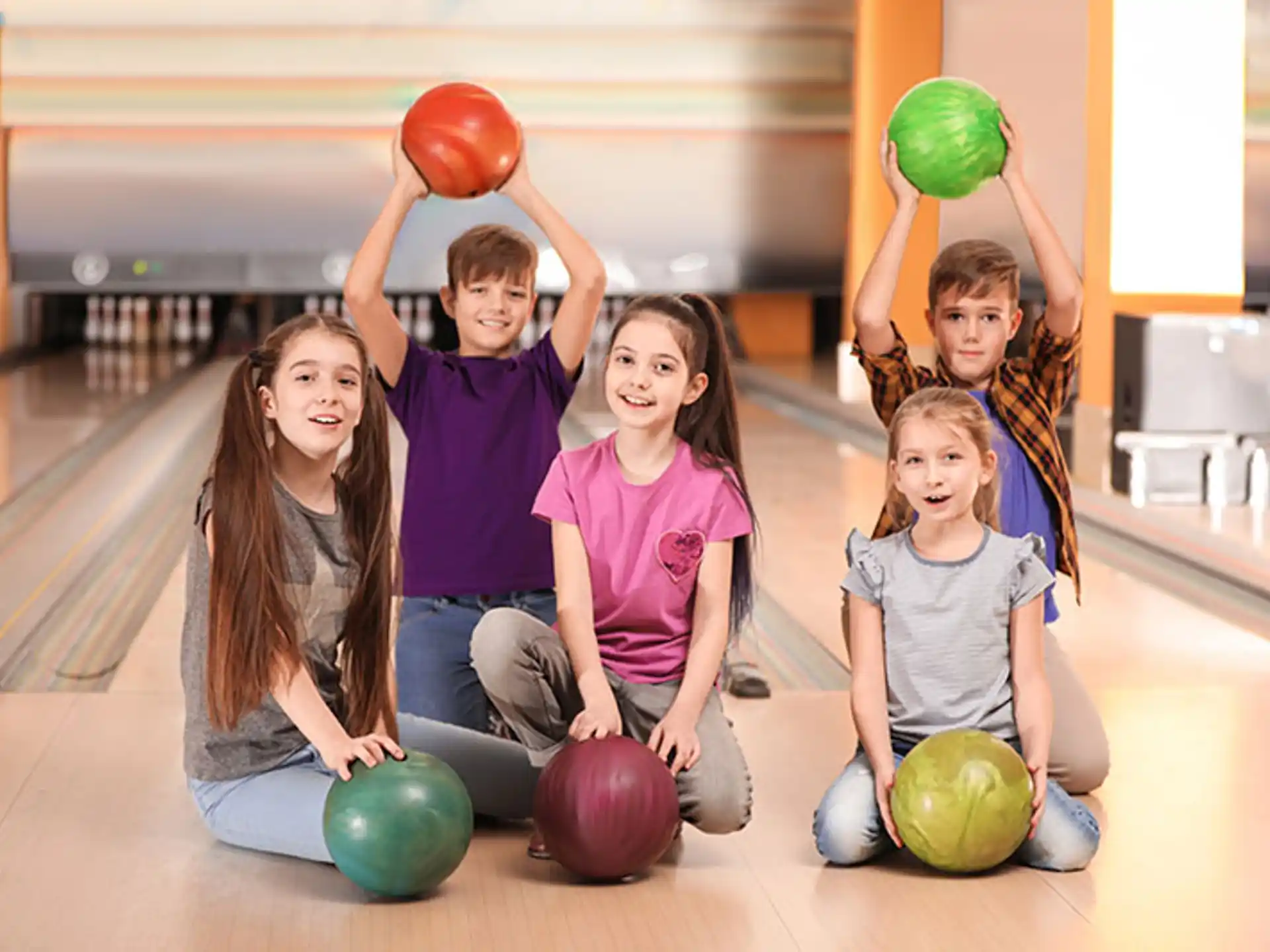 a group of kids holding balls