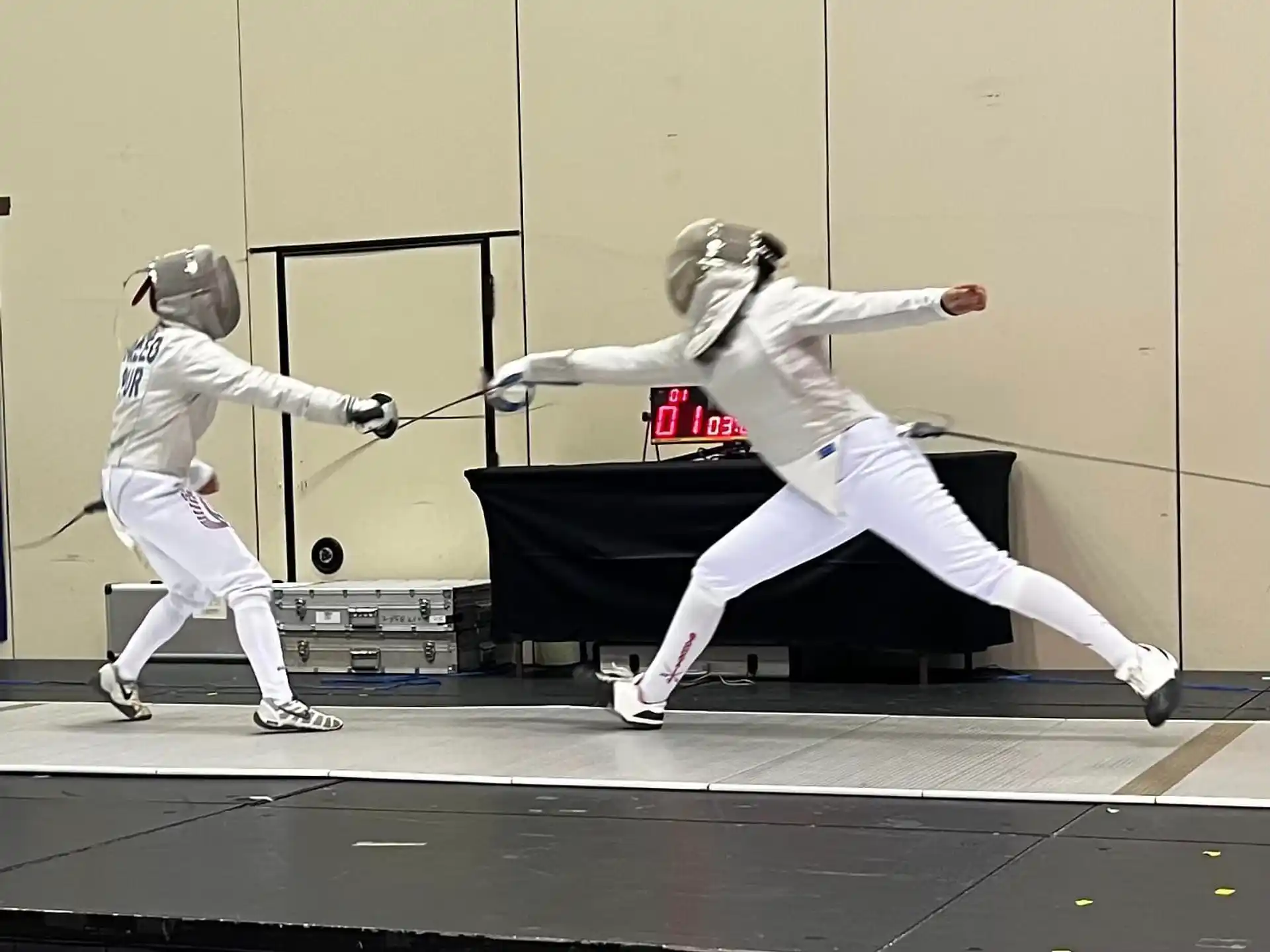 a couple of people in white uniforms holding swords and posing for the camera