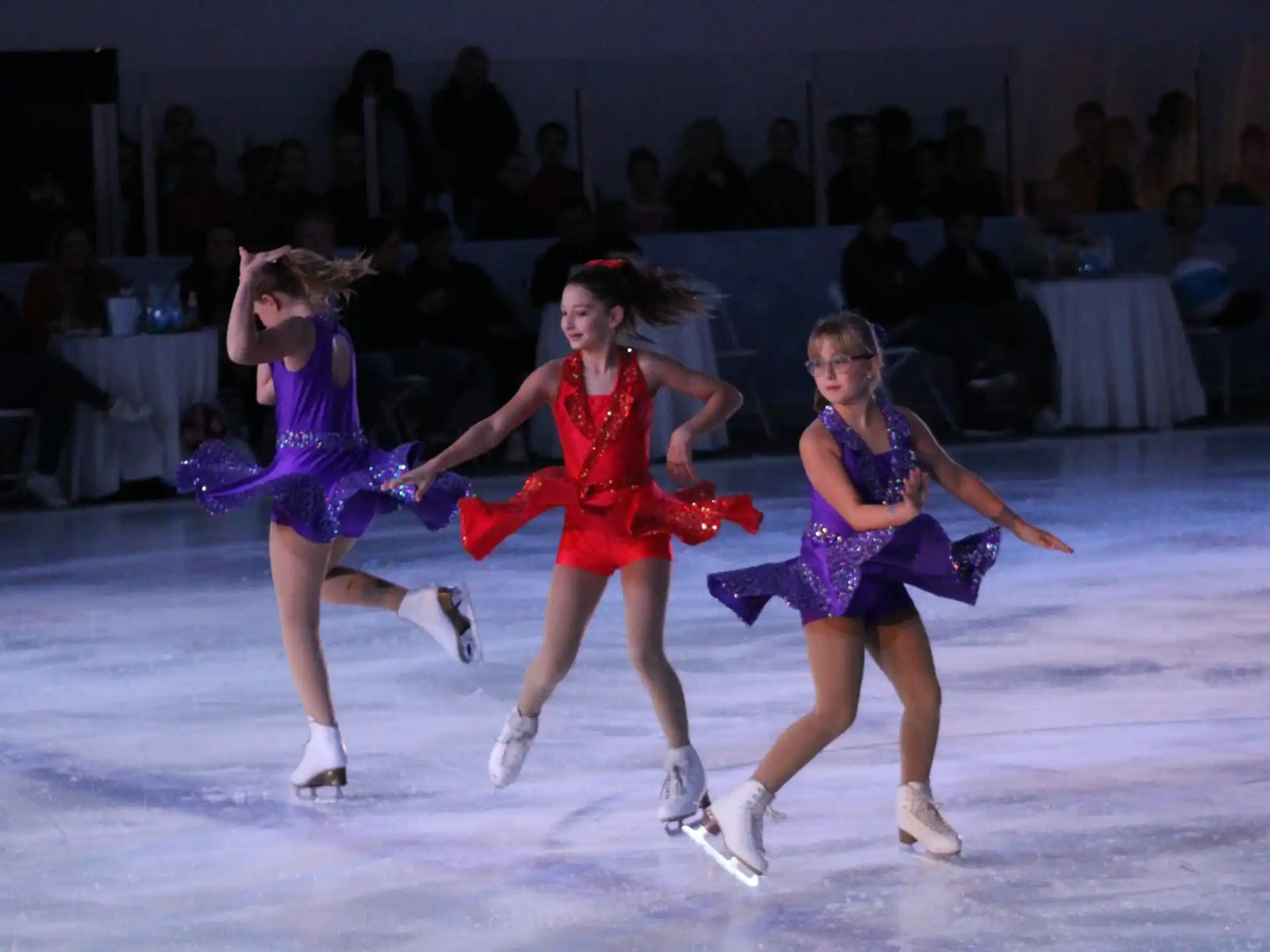 a group of women ice skating