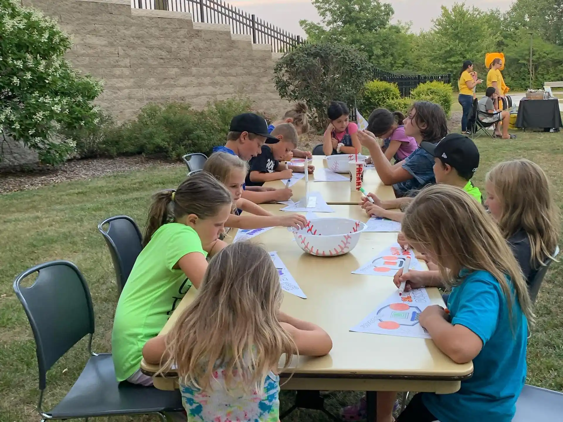 a group of people sitting around a table outside