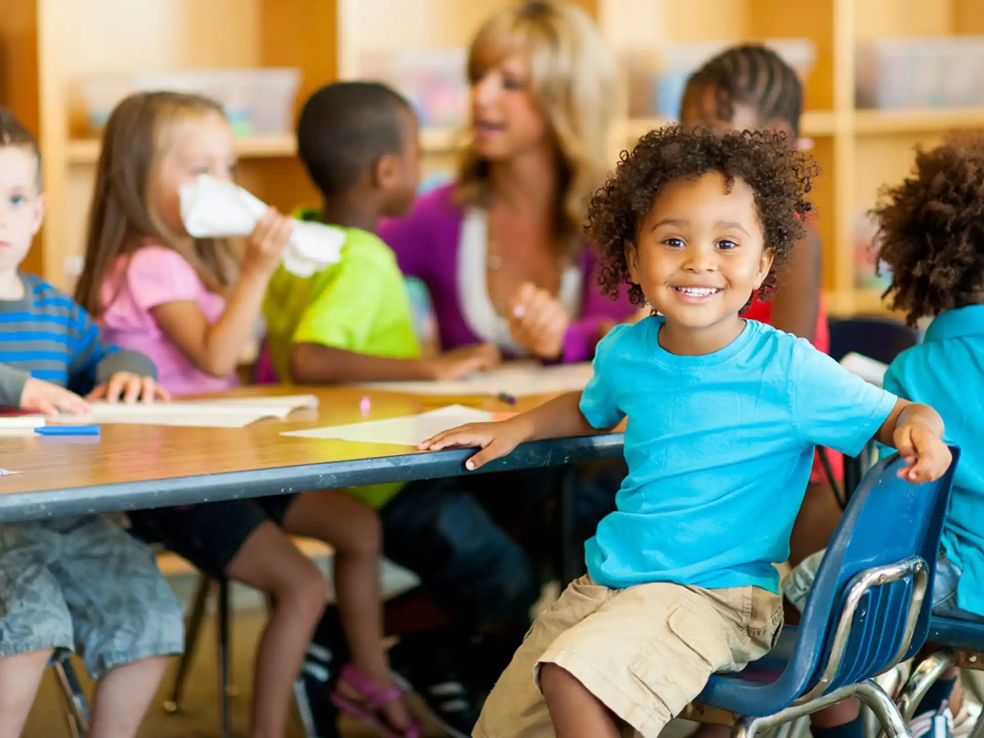a group of children sitting at a table
