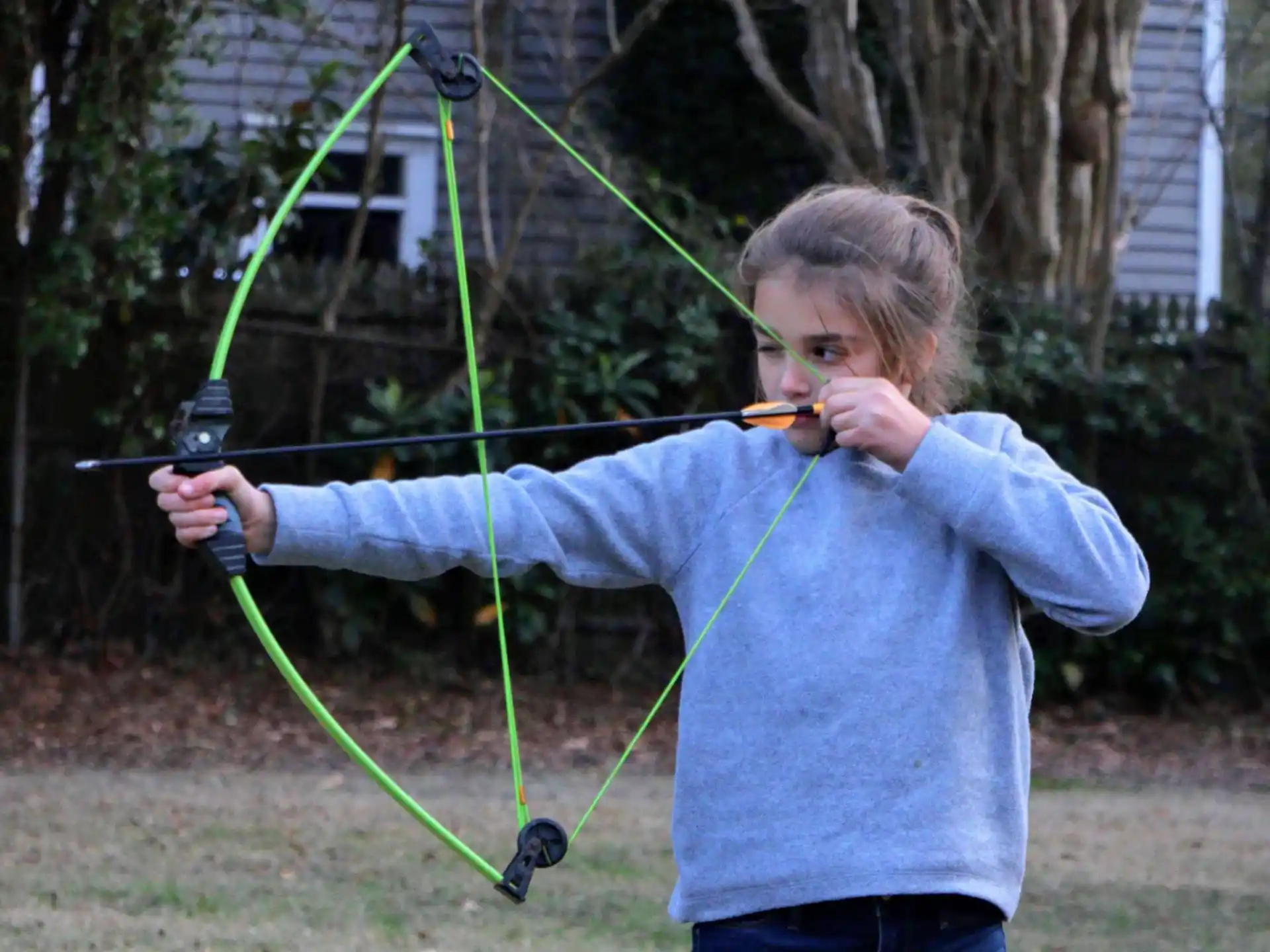 a boy holding a bow and arrow