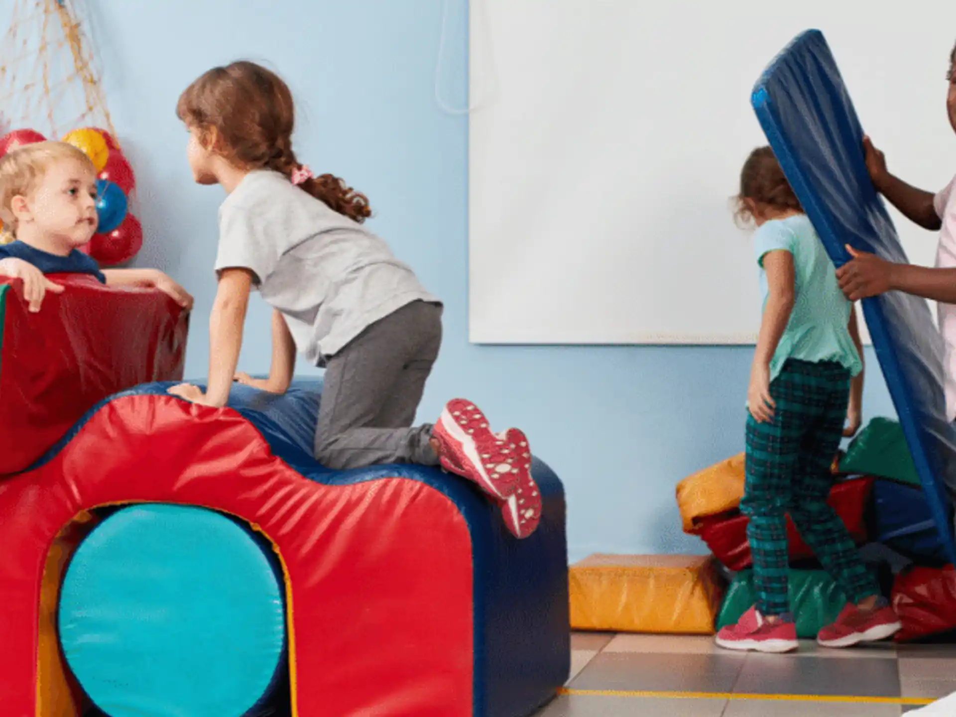 a group of children playing on a playground toy