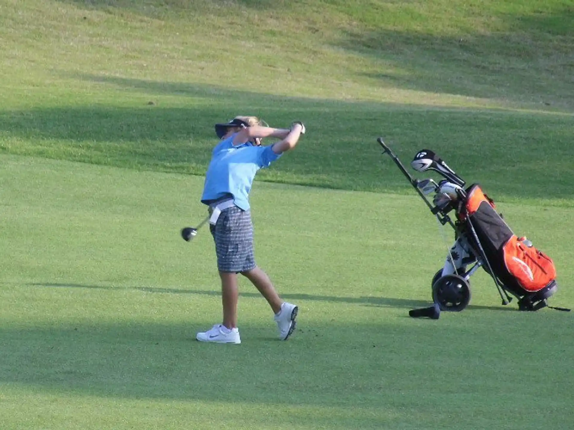a person swinging a golf club