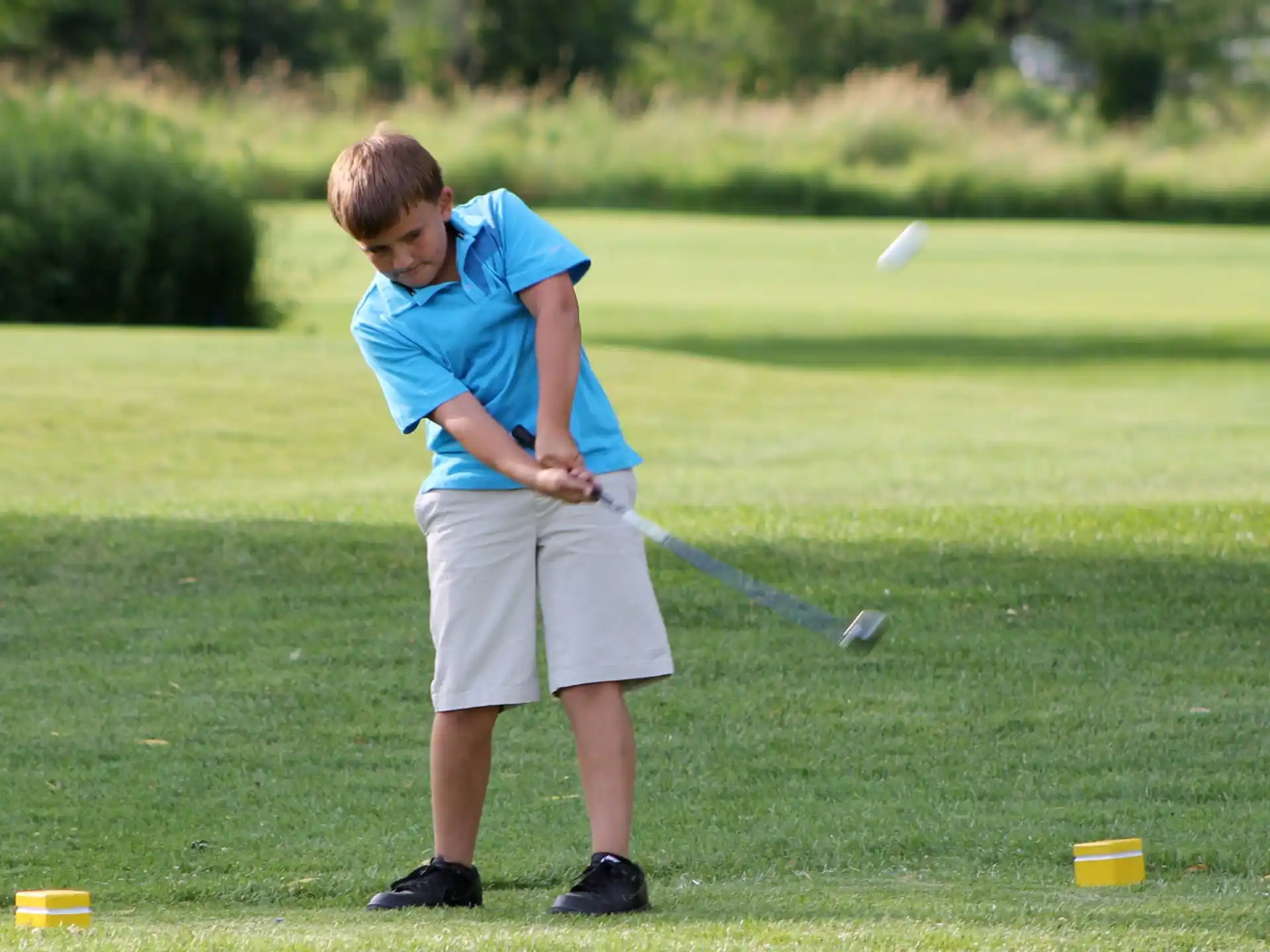 a boy playing golf