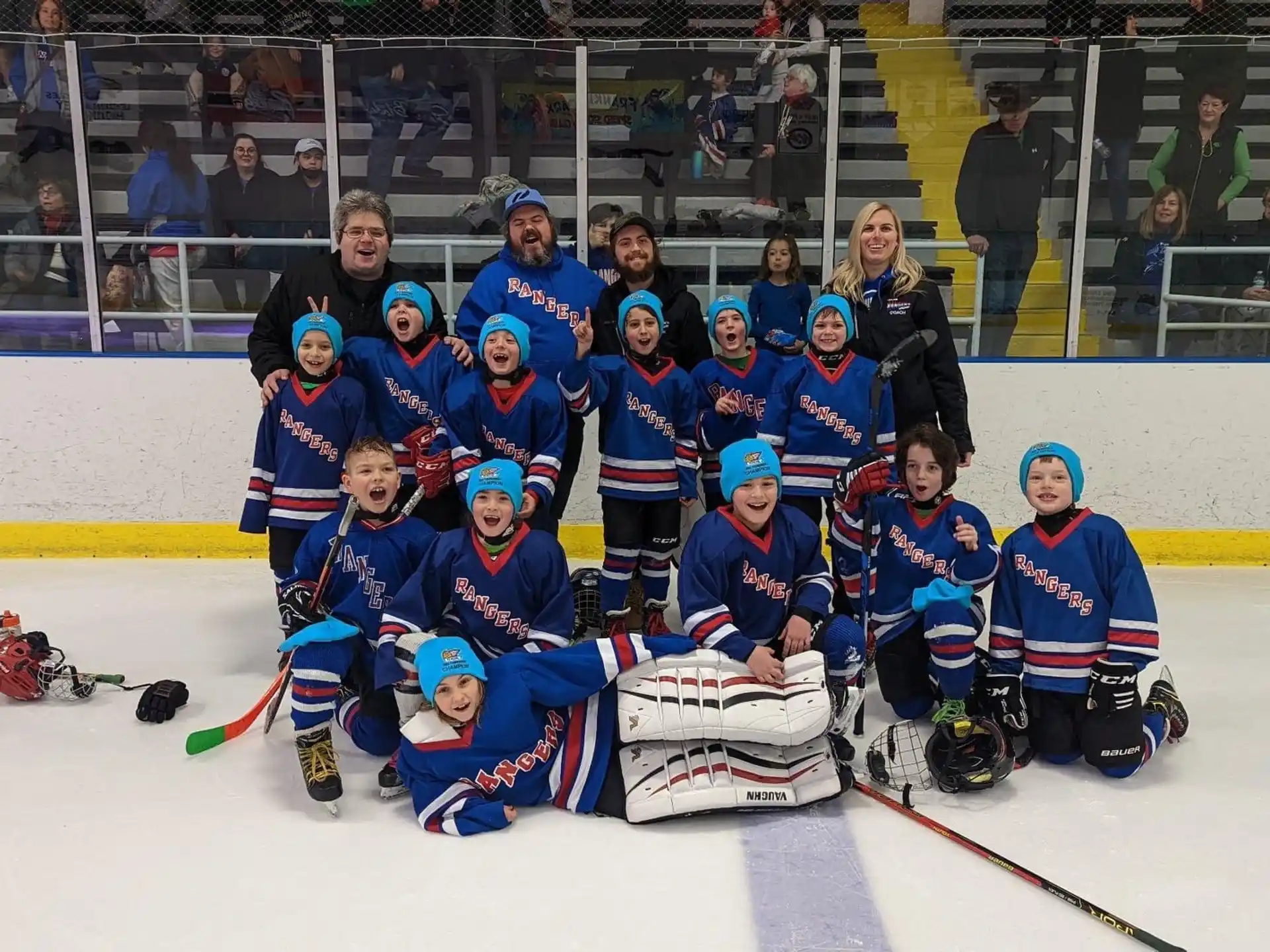 a group of people wearing hockey uniforms and posing for a photo
