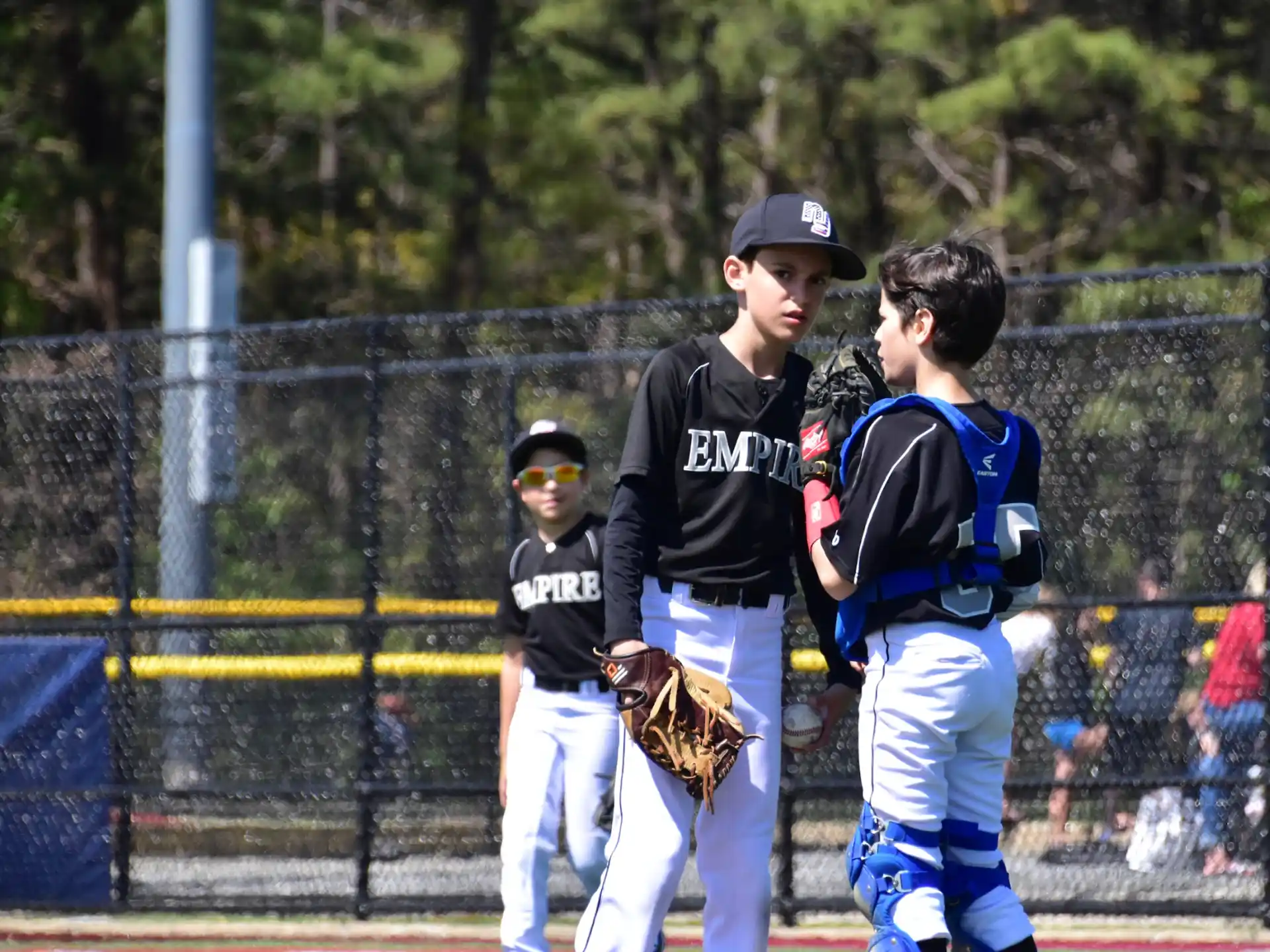 a group of kids playing baseball