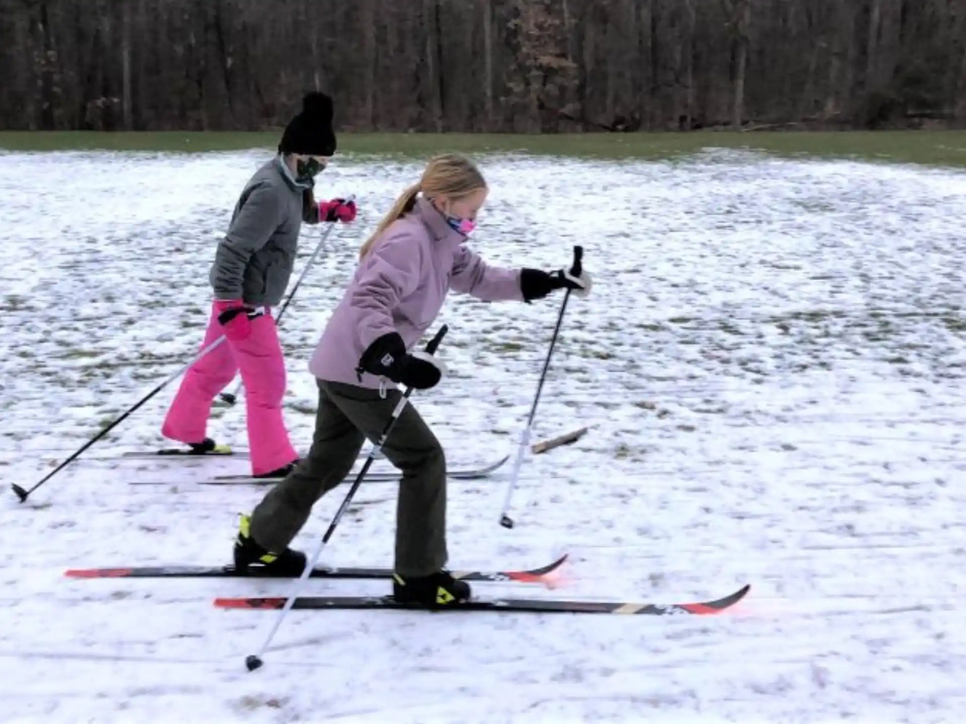 a couple of people skiing on the snow