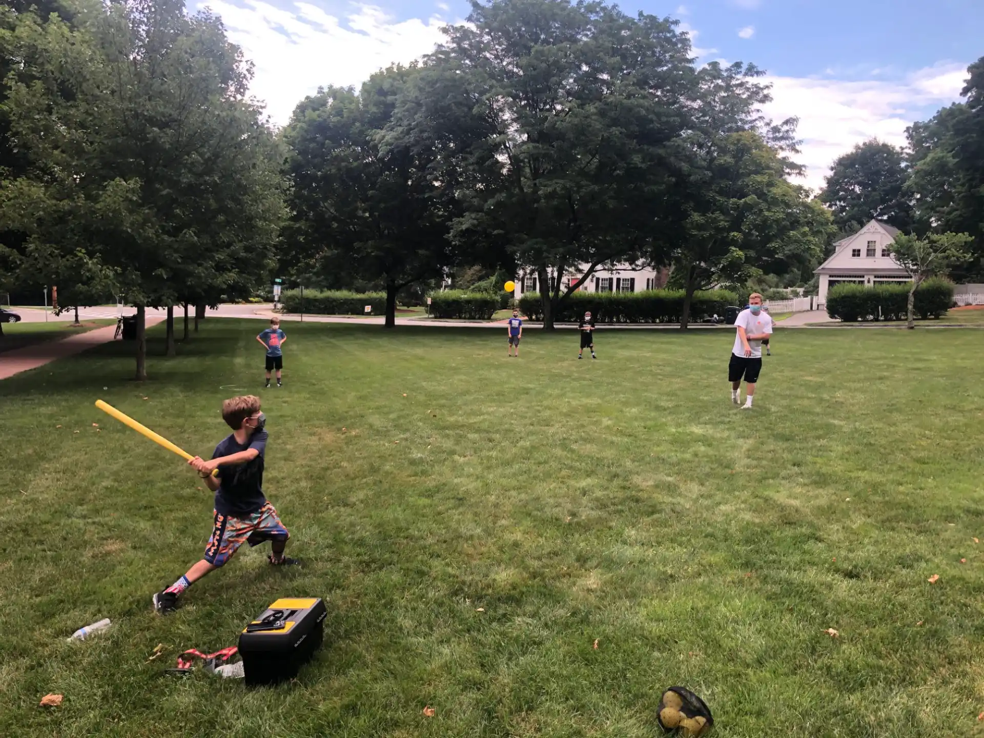 a group of kids playing baseball
