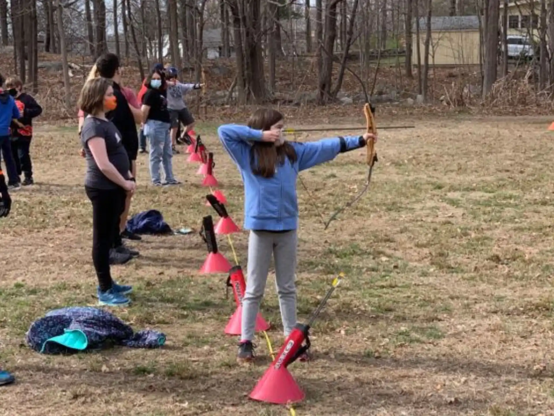 a group of people playing with sticks