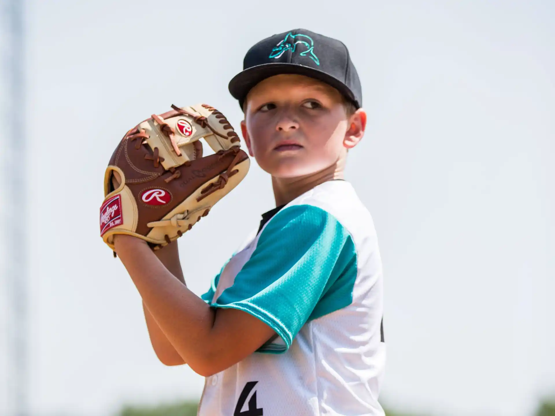 a boy wearing a baseball glove