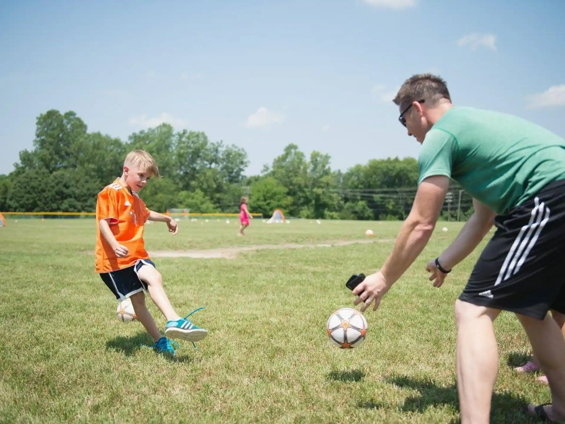 a person and a boy playing football