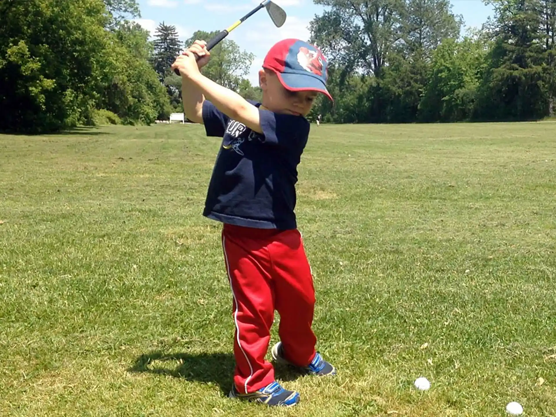 a boy swinging a baseball bat