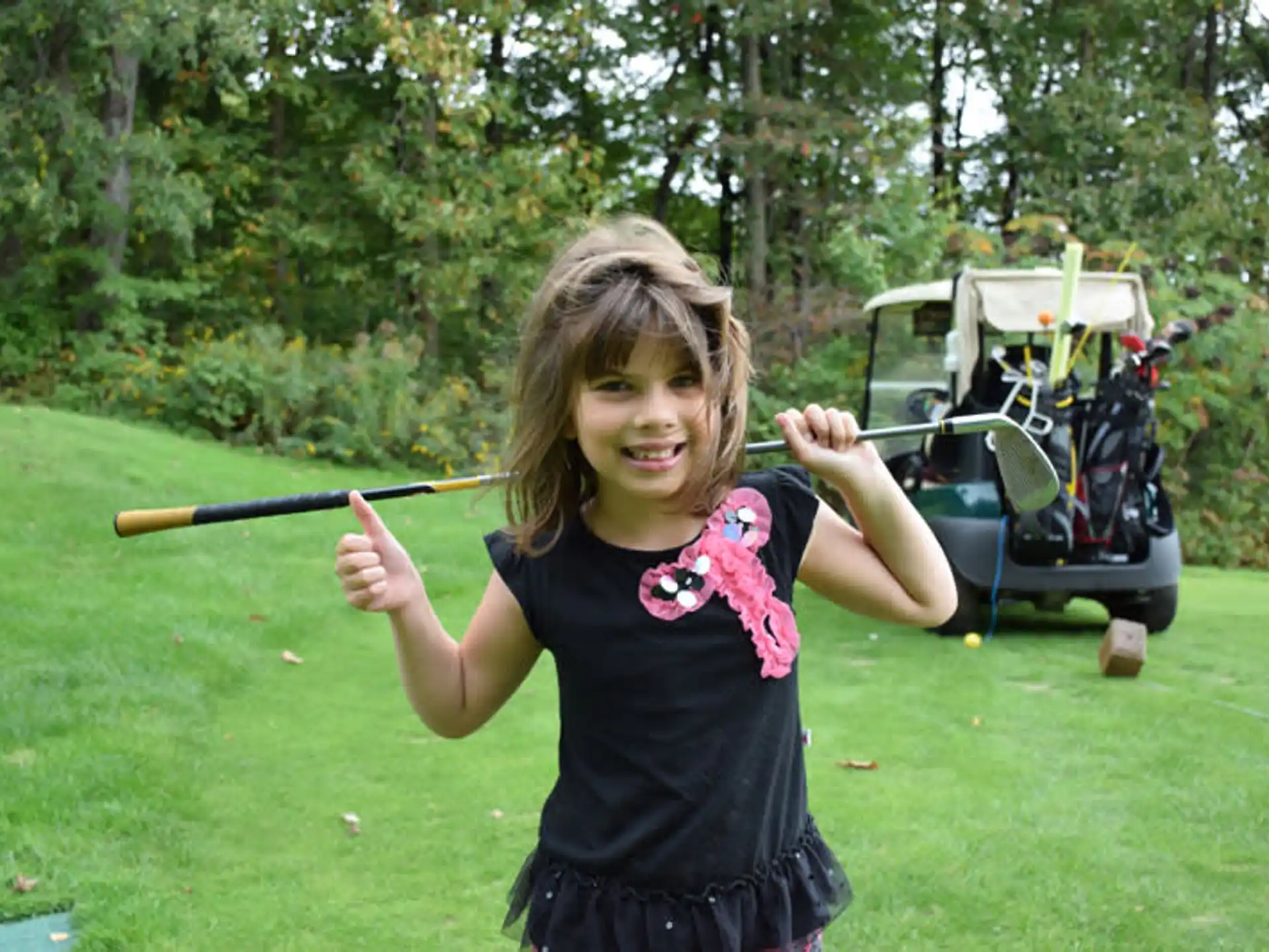 a girl holding a golf club