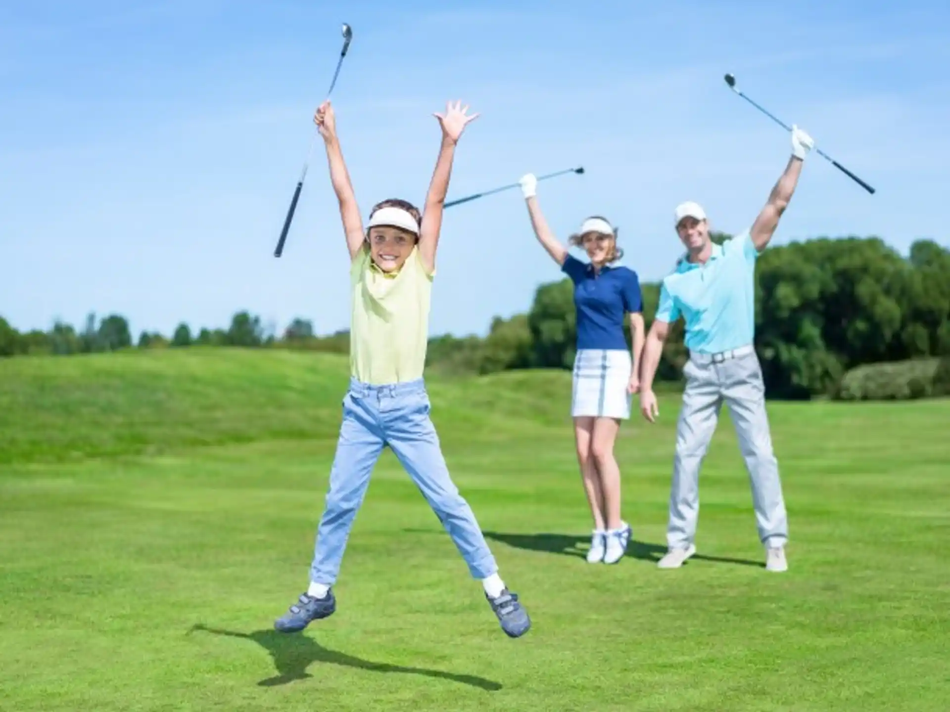 a group of people holding golf clubs