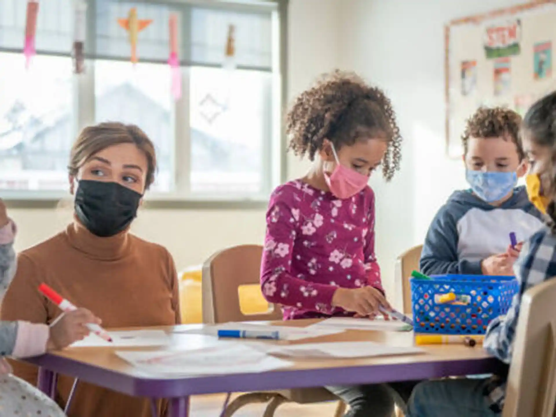 a group of children sitting at a table