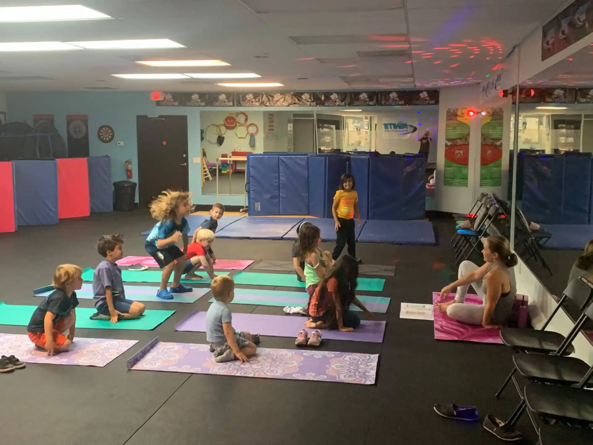 a group of children sitting on mats