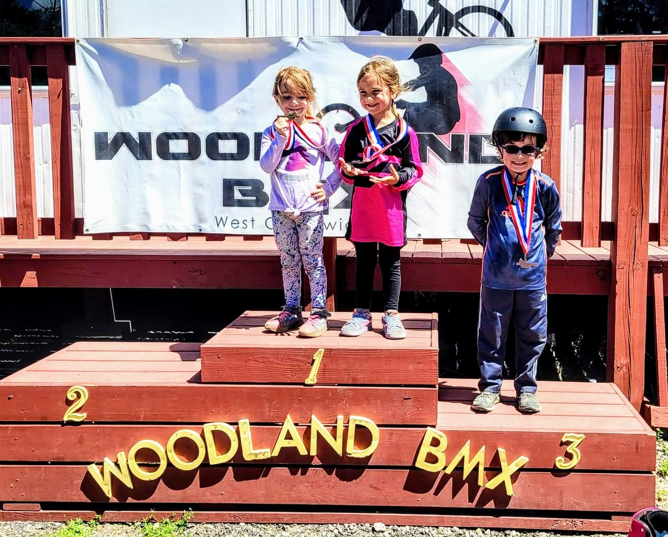 a group of children standing on a wooden platform