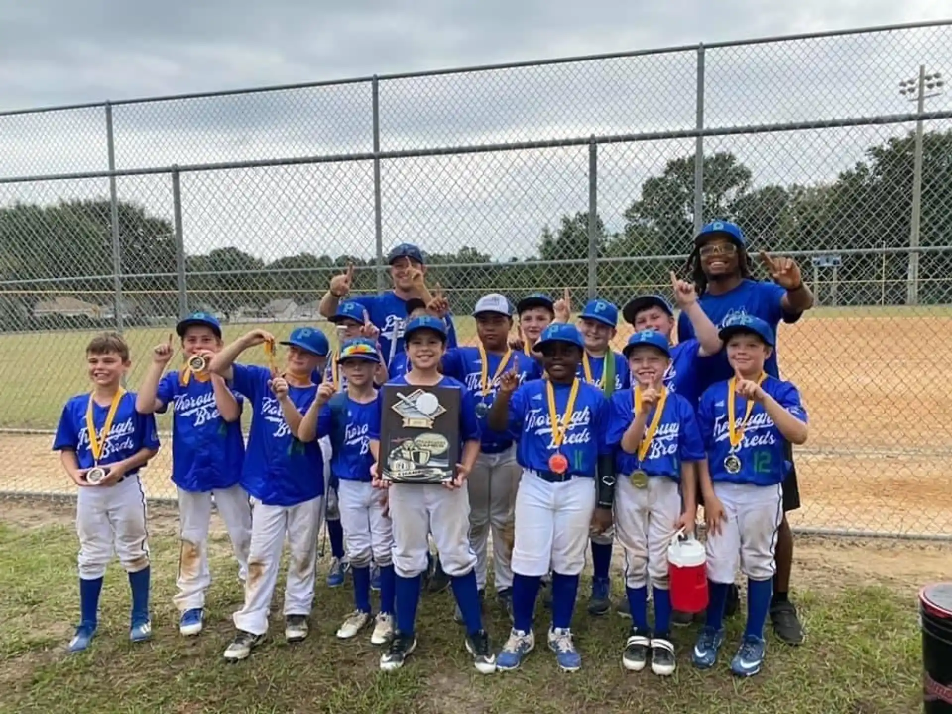 a group of kids wearing blue uniforms